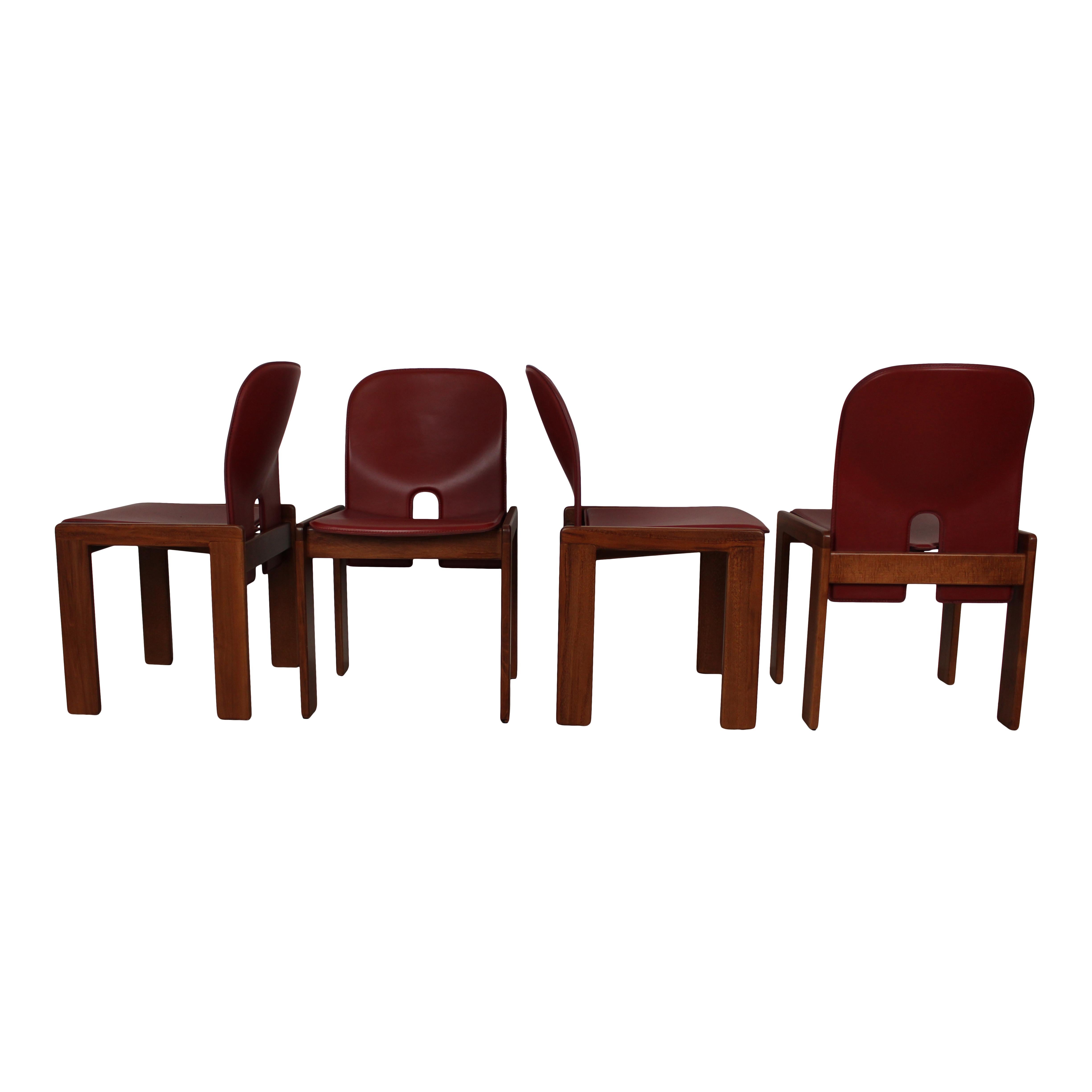 Set of four Model 121 dining chairs, designed by Afra and Tobia Scarpa and produced by the Italian manufacturer Cassina in 1967.
They feature English red leather upholstery and a walnut structure.

Fully restored in Italy.

Afra and Tobia Scarpa
