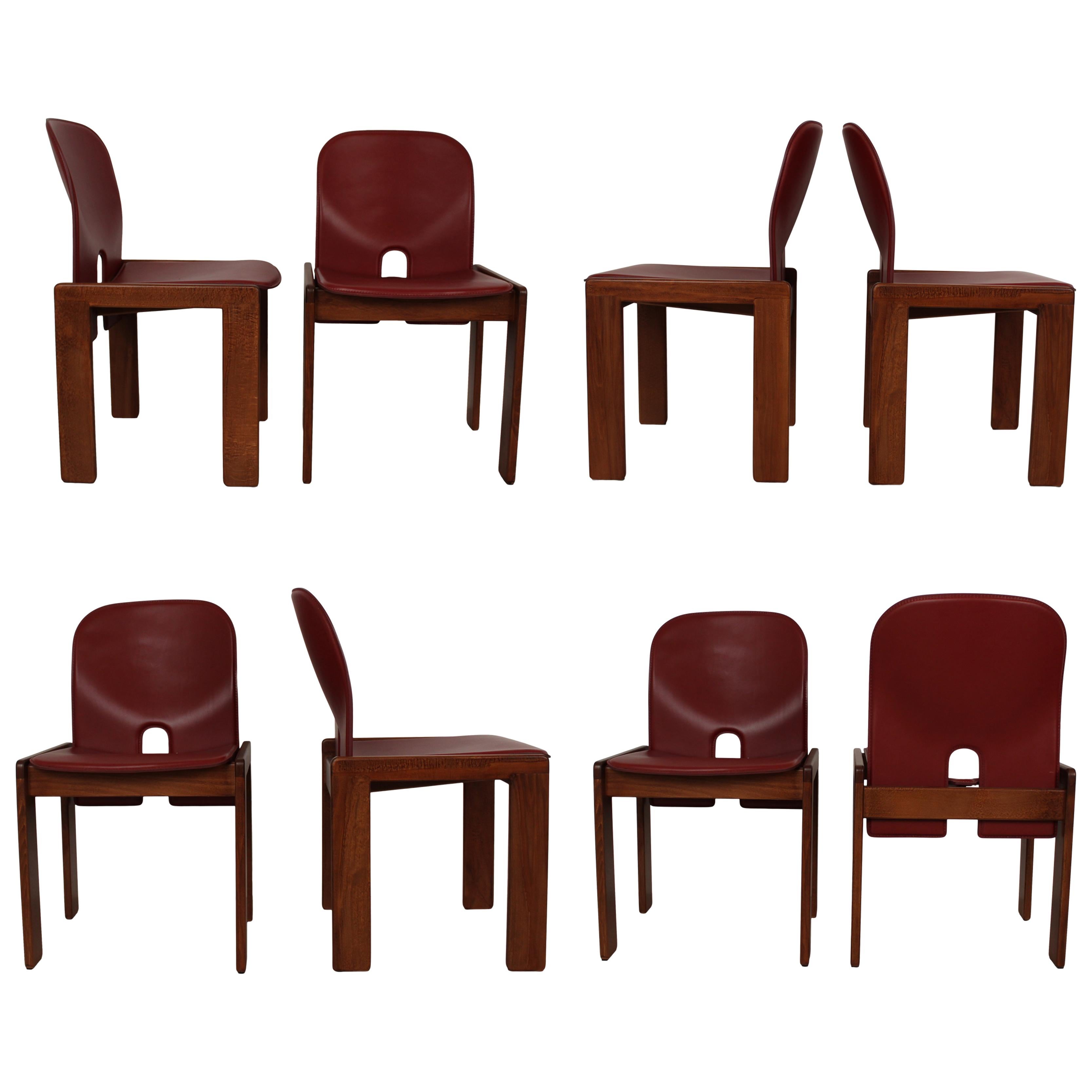 Set of eight Model 121 dining chairs, designed by Afra and Tobia Scarpa and produced by the Italian manufacturer Cassina in 1967.
They feature English red leather upholstery and a walnut structure.

Fully restored in Italy.

Afra and Tobia Scarpa