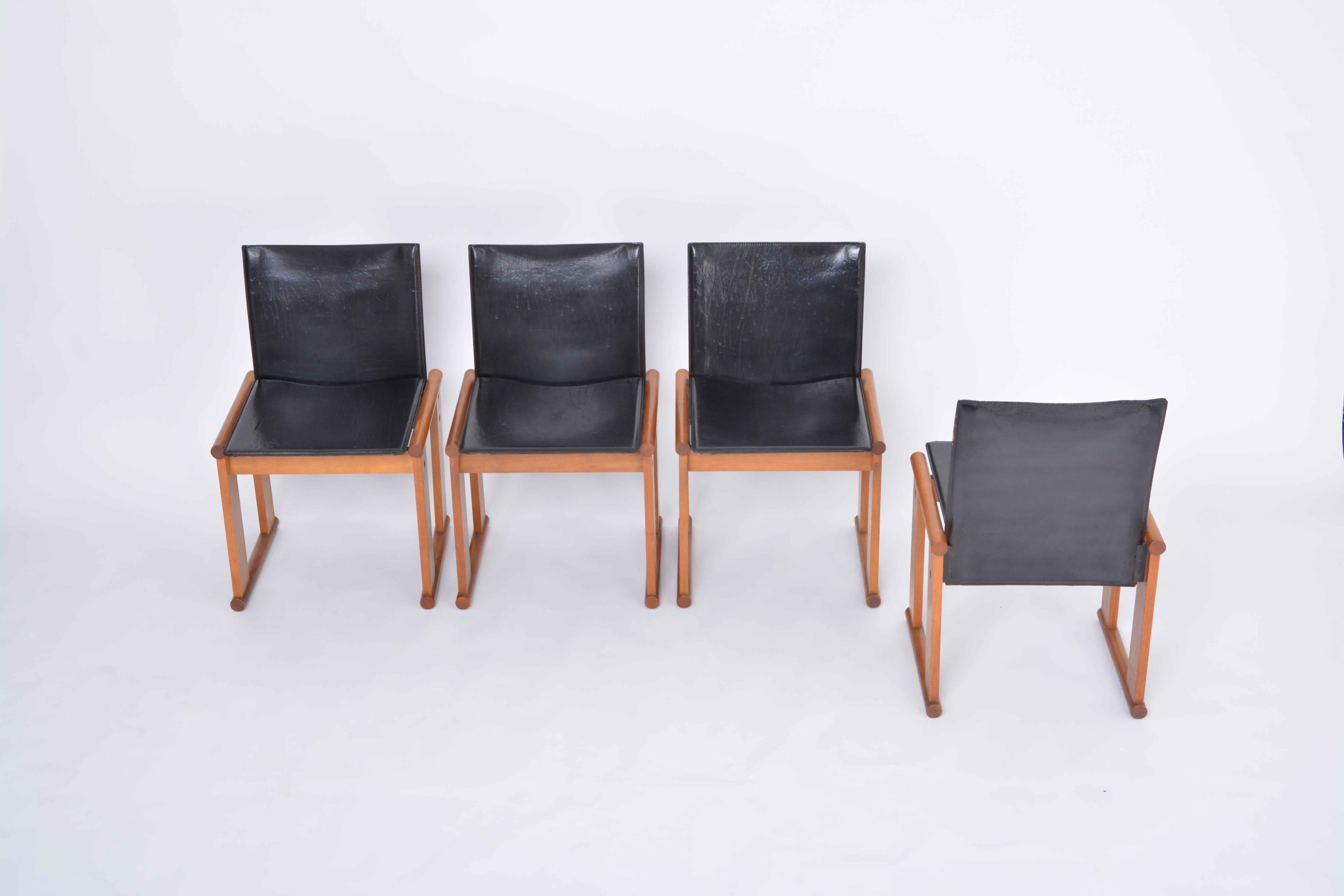 This set of four dining chairs shows strong resemblance to two designs of famous Italian designers Afra & Tobia Scarpa: the 'Monk' chairs (1974) and the 'Dialogo' chairs (1970s) who also have very similar ectangular frames angular backrests. This