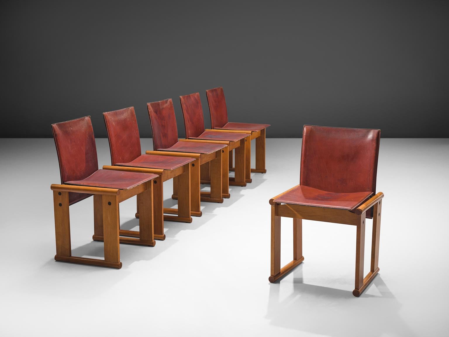 Afra & Tobia Scarpa for Molteni, set of six dining chairs, patinated teak and red leather, Italy, circa 1978.

The wonderfully red leather forms a striking combination with the blond wood. Interesting is the 'flat' shape of this chair where the