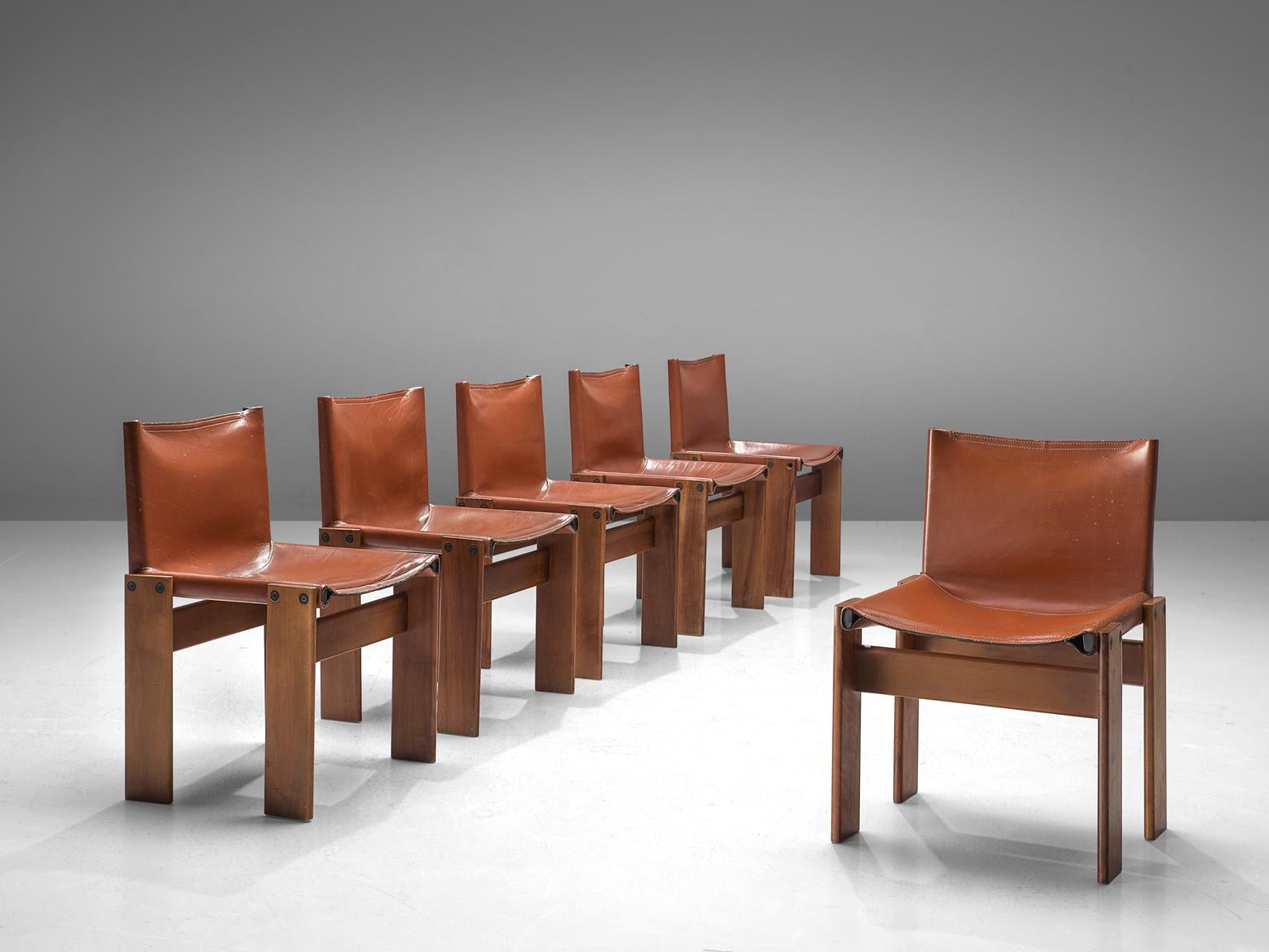 Afra & Tobia Scarpa, set of six monk dining chairs, wood and patinated cognac leather, Italy, 1974.

The wonderfully dark red leather forms a striking combination with the walnut wood. Interesting is the 'flat' shape of this chair where the