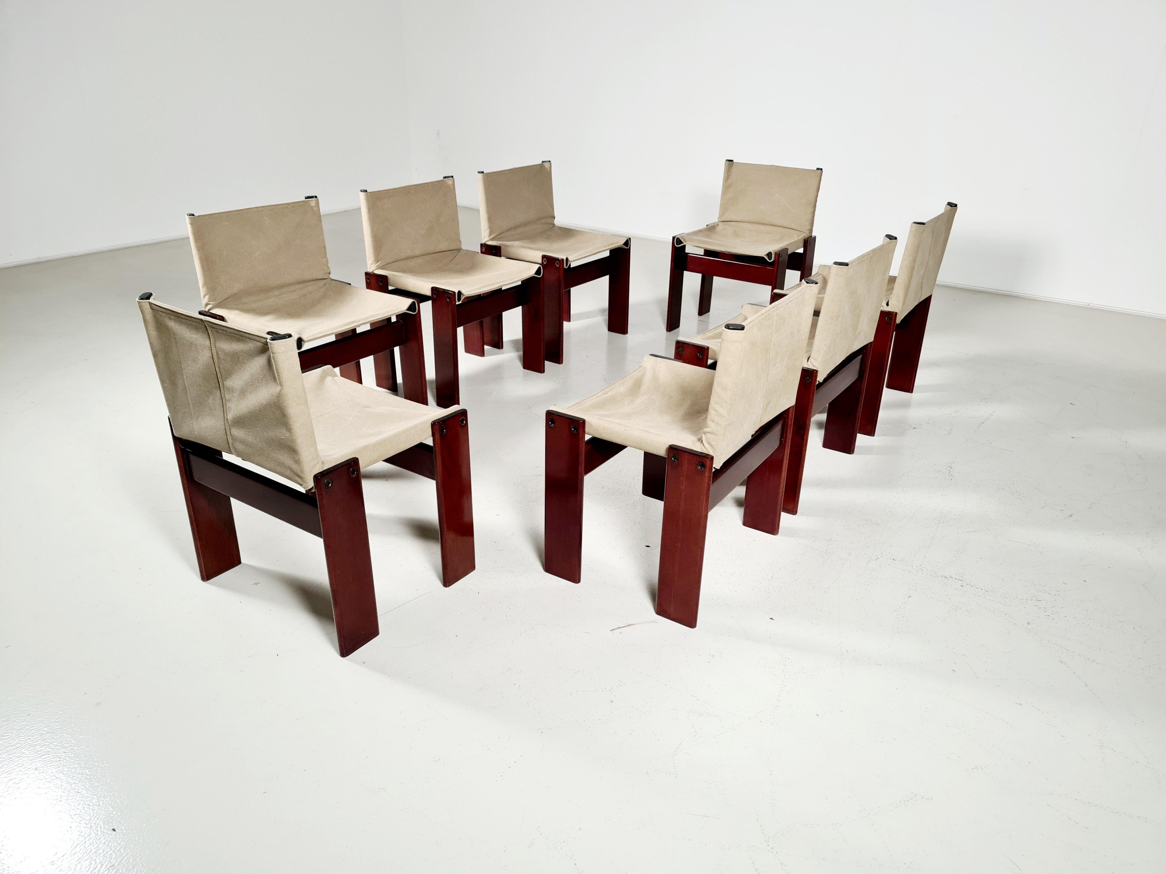 A set of 8 mahogany wood and canvas dining chairs, model Monk, for Molteni, Italy, 1970s.

The new canvas forms a beautiful combination with the wood. An interesting and high-quality chair. Simple and solid design by Italian award-winning designers