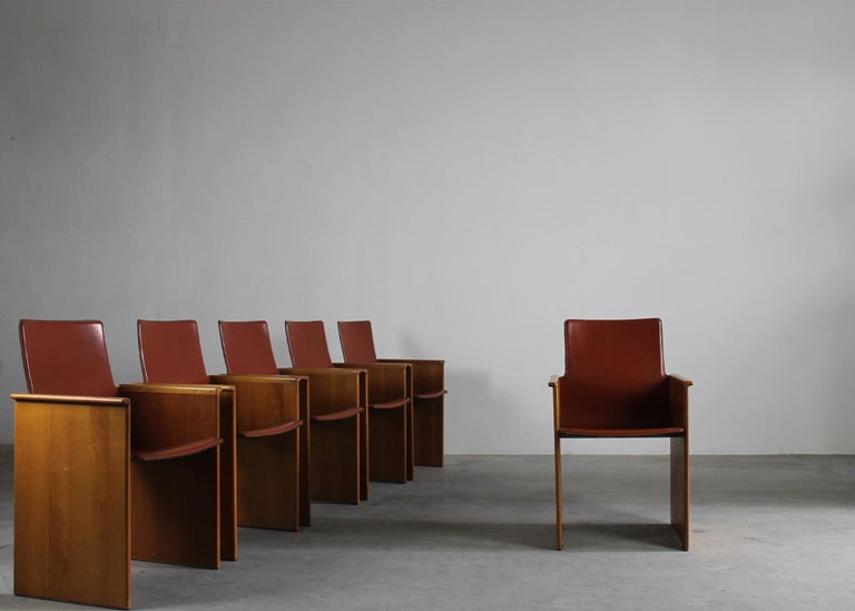 Set of six Torcello chairs with structure and armrests in walnut wood, back and seat were realized in high-quality leather.
The Torcello chair was originally designed by the iconic duo Tobia and Afra Scarpa for Stildomus in 1976. 

Tobia Scarpa