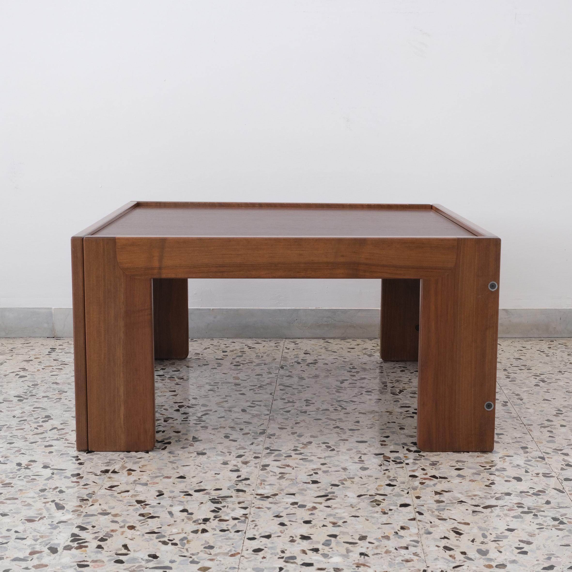 A square walnut low table, the top plate rested on the frame supported by four rectangular feet.
With 
