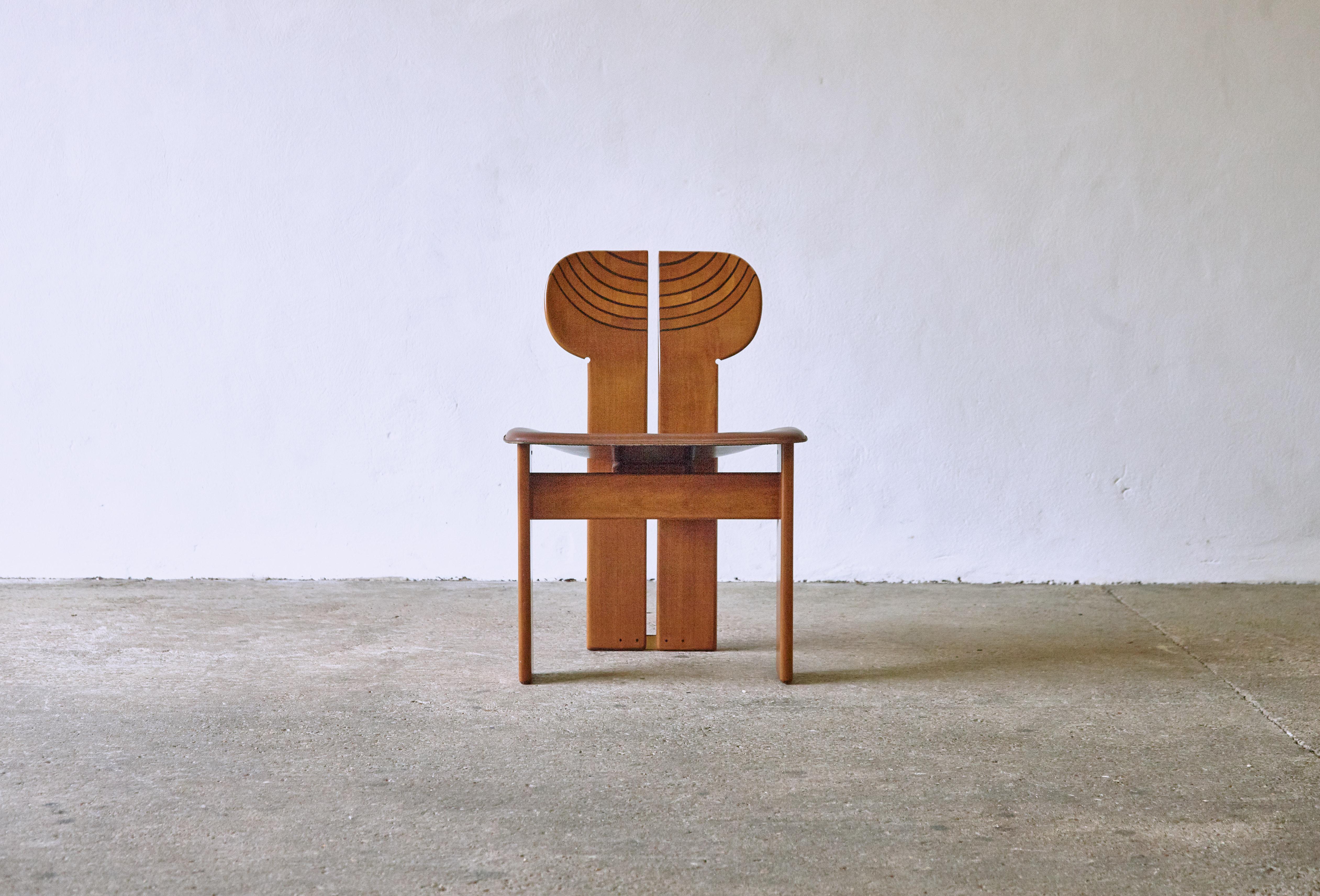 A superb Africa chair designed by Afra & Tobia Scarpa in the 1970s and produced by Maxalto, Italy. Walnut, burl, black leather and brass. Good original condition with minor age related signs of use and wear. The original leather seat is in good