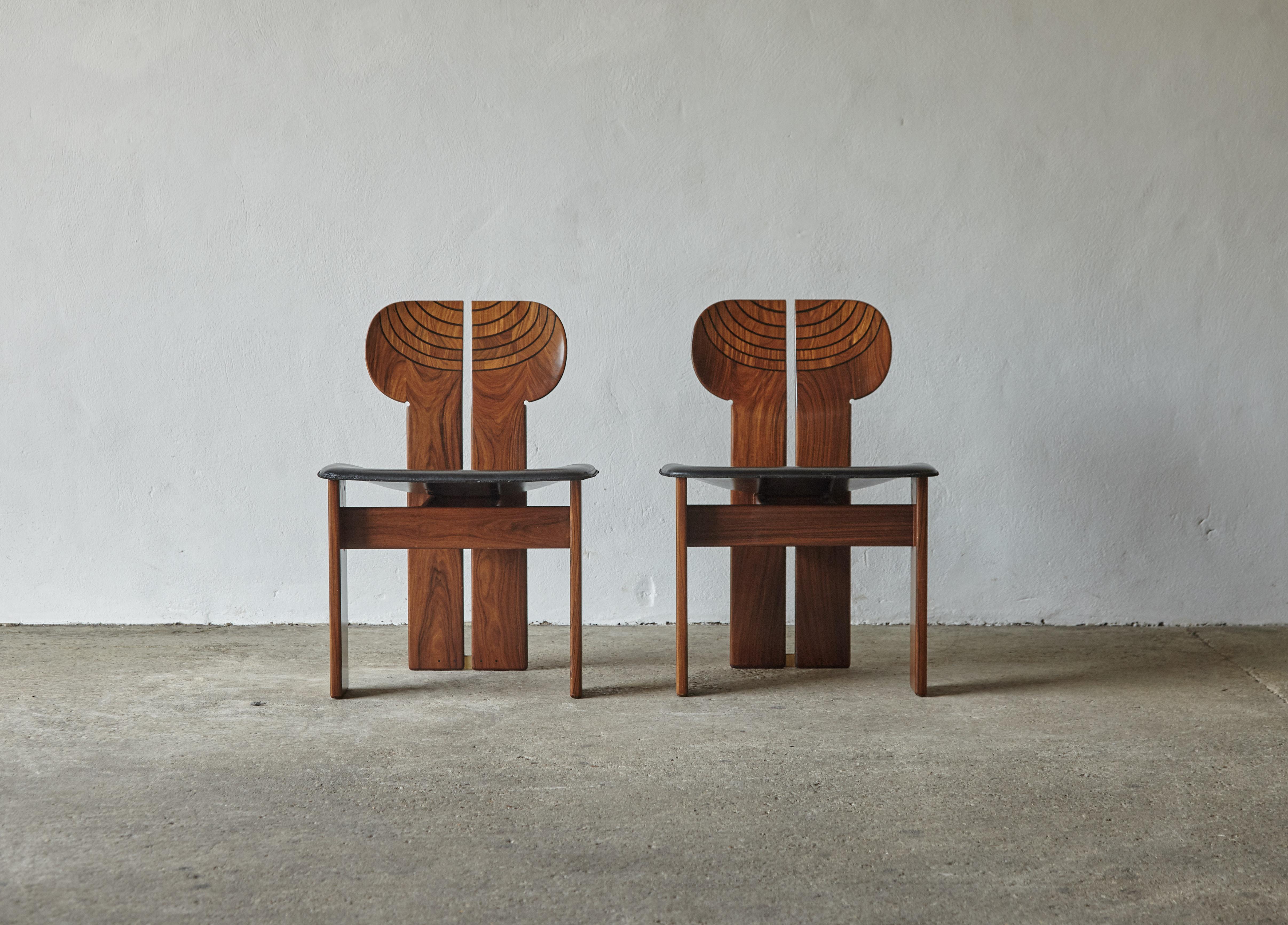 A pair of stunning Africa chairs designed by Afra & Tobia Scarpa in the 1970s, and produced by Maxalto, Italy. These are fine examples in rare exotic hardwood with extraordinary figuring, burl, black leather and brass. Good original condition with