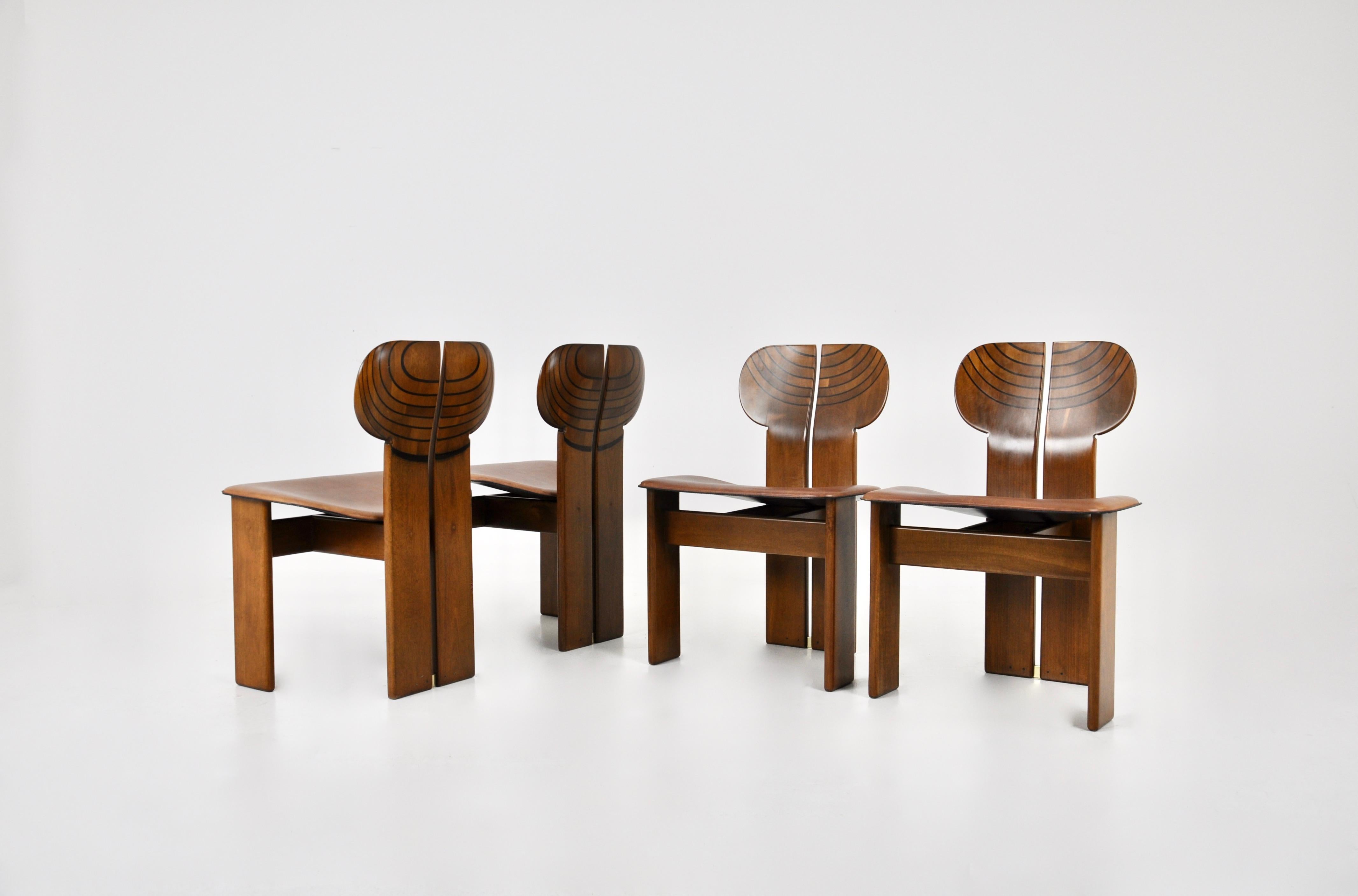 Set of 4 Africa chairs in wood and brown leather by Afra & Tobia Scarpa . Stamped. Seat height: 45 cm. Wear due to time and age of the chairs.