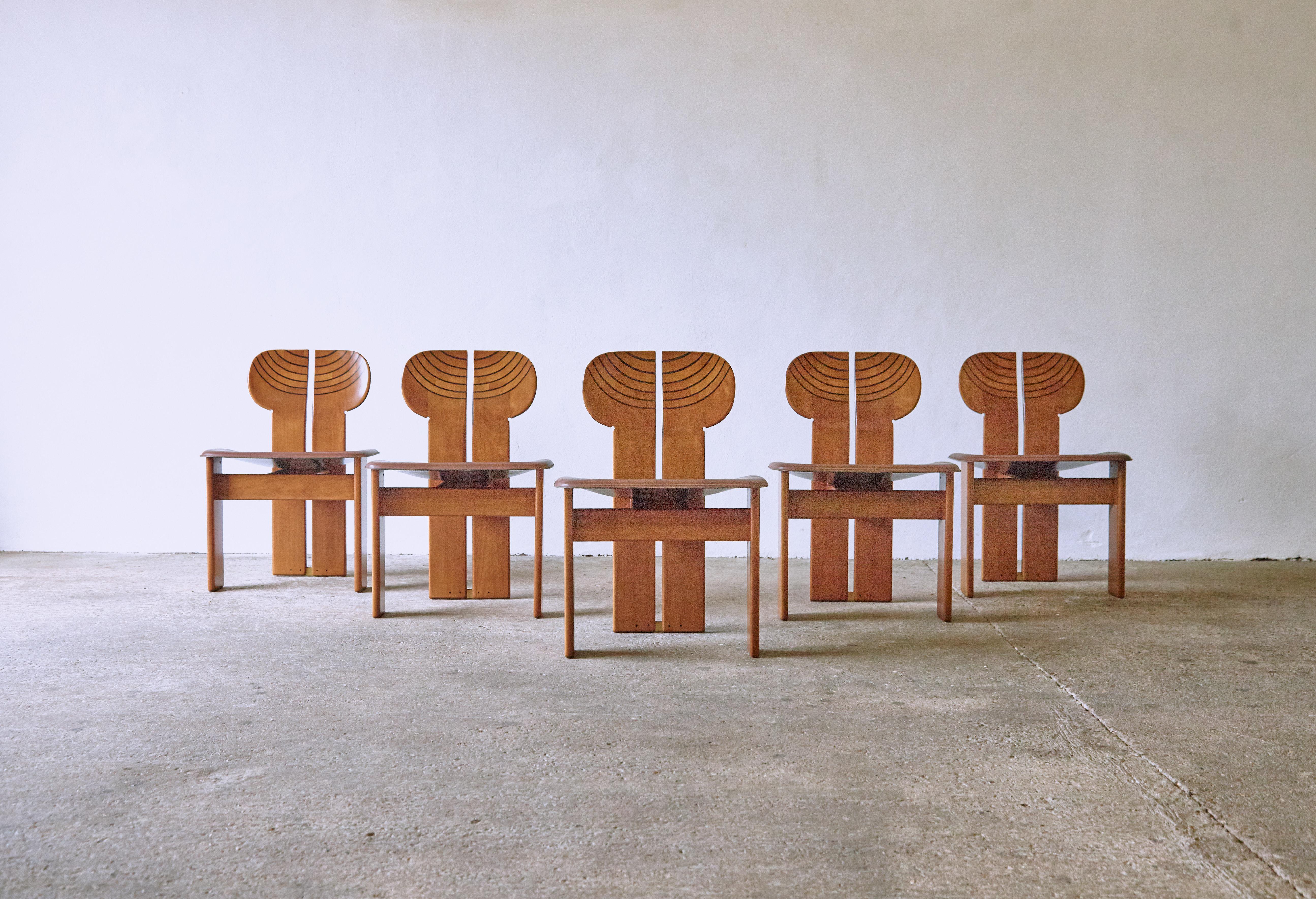 ** Please note only 4 chairs are sold with this set ** A superb set of four Africa chairs with matching dining table designed by Afra & Tobia Scarpa in the 1970s, and produced by Maxalto, Italy. Walnut, burl, black leather and brass. Good original