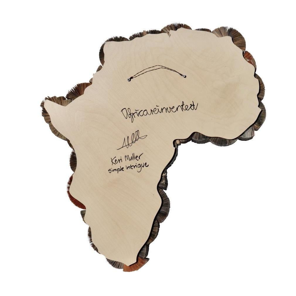 “Africa Reinvented” by Keri Muller of Simple Intrigue, Cape Town, South Africa. A contemporary soft sculpture created from repurposed used paperback books retaining the binding of the pages, folding each individual page and creating wheels of form.