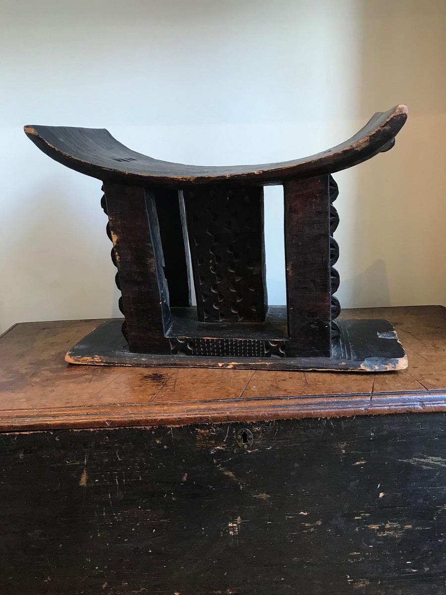 A great example of a mid to late 20th century African Ashanti stool. Carved from one piece of wood, showing geometric incisions typical to the Ashanti stools. Solid wood blackened. These stools were generally used by the men in the tribe. They are