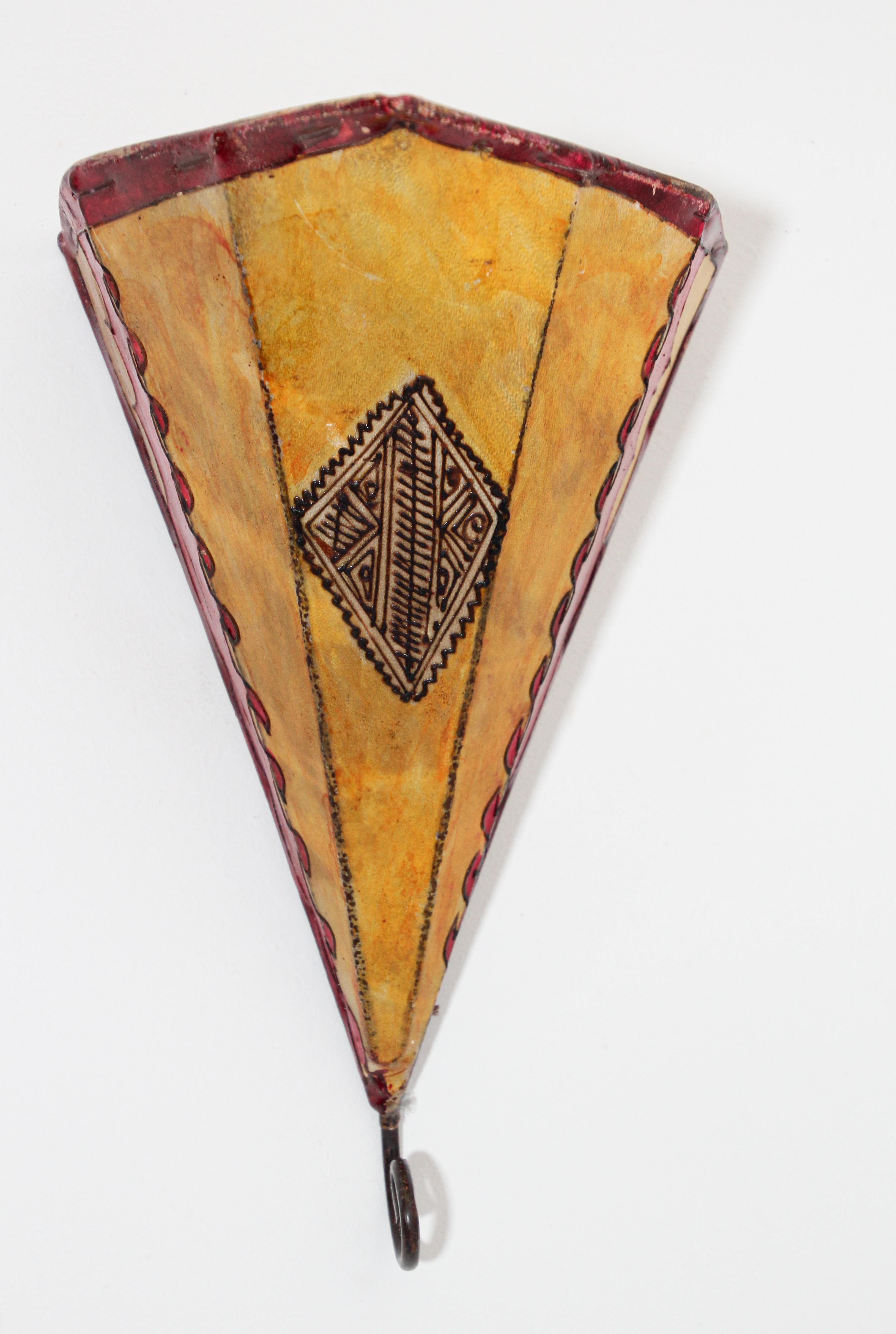 African Tribal Art parchment wall shade sconce featuring a large triangle hide form stitched on iron and hand painted surface.
These Art pieces could be used as wall lamp shade.
Iron frame covered with hide parchment which has been hand painted with