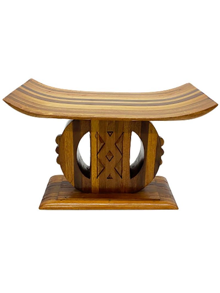African Ashanti-Asante style wooden stool

A 20th century Ashanti form wooden stool with a wide, rectangular and curved seat on a rectangular base plate in between a round central support.

The stool measures 36 cm high, 56,5 cm wide and the