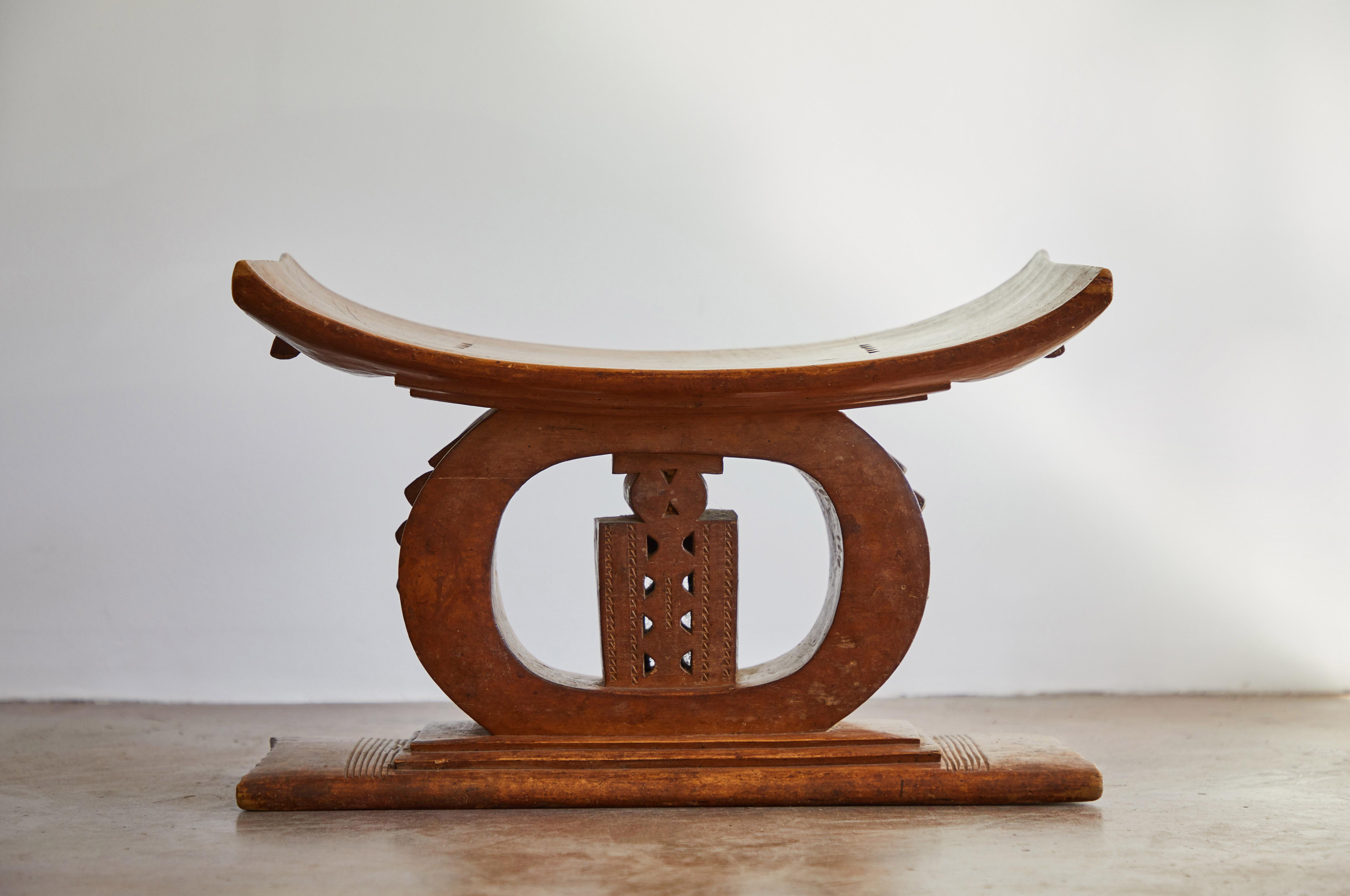 Elaborate hand carved wood Ashanti stool. Made in Ghana, circa early 20th century.