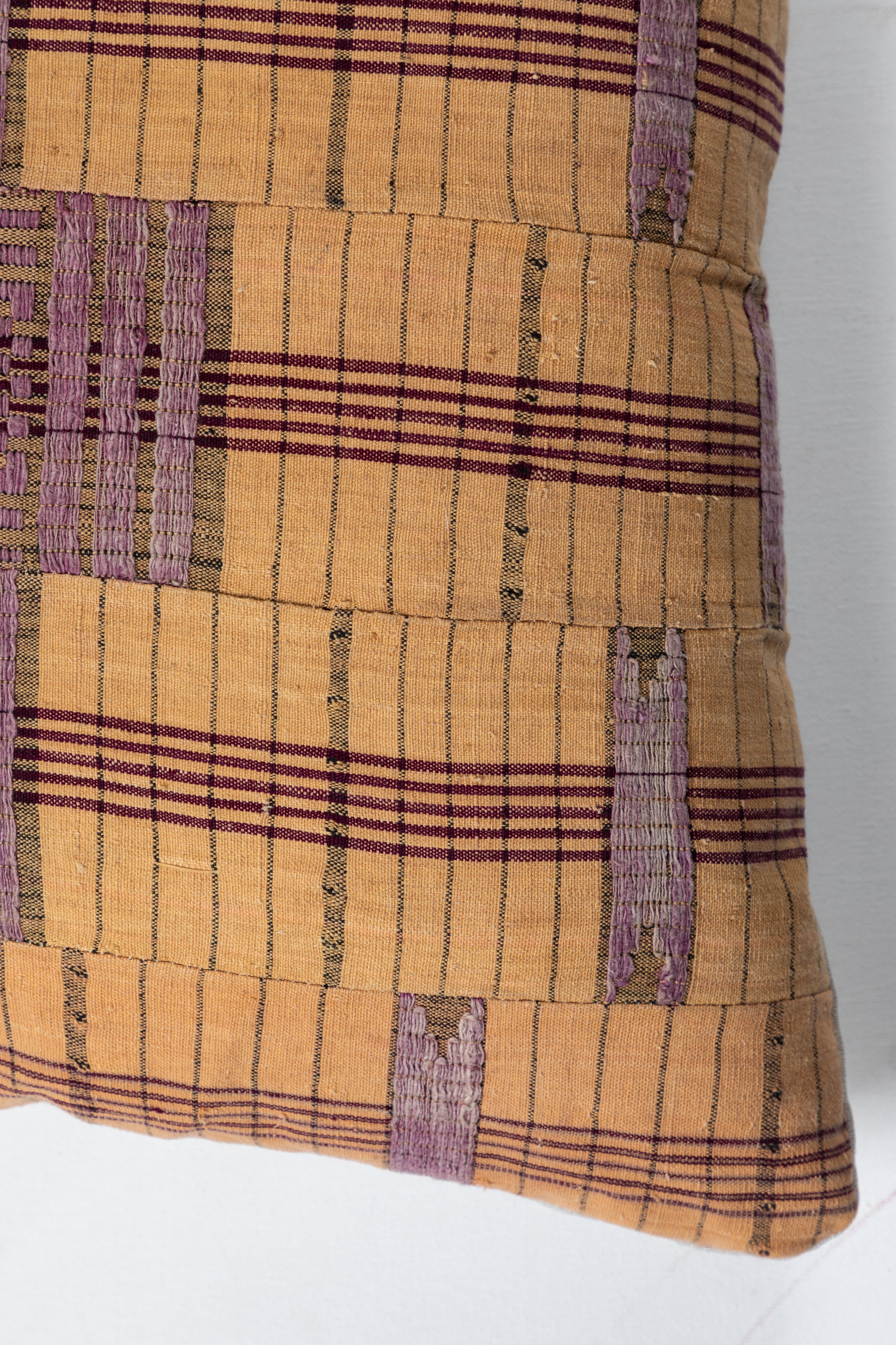 Pillow made using vintage Asoke fabric. Handwoven in Nigeria by the Yoruba peoples. Long strips of cotton and raw silk made on narrow looms and sewn together. Natural linen back. Invisible zipper and feather and down fill.
