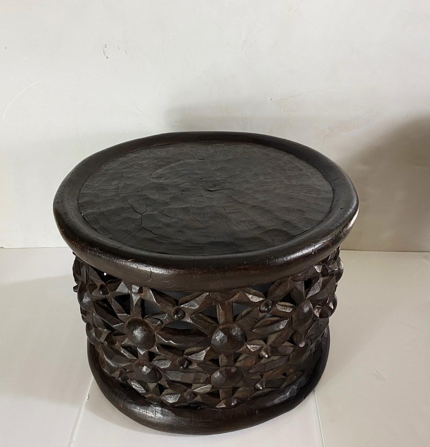 Authentic Bamileke Stool from Cameroon. Beautiful 20th-century (c. 1960) carving with a large diameter and unique design can be used as a coffee table or side table.
Hand-carved from one continuous piece of wood. A unique design and a true work of