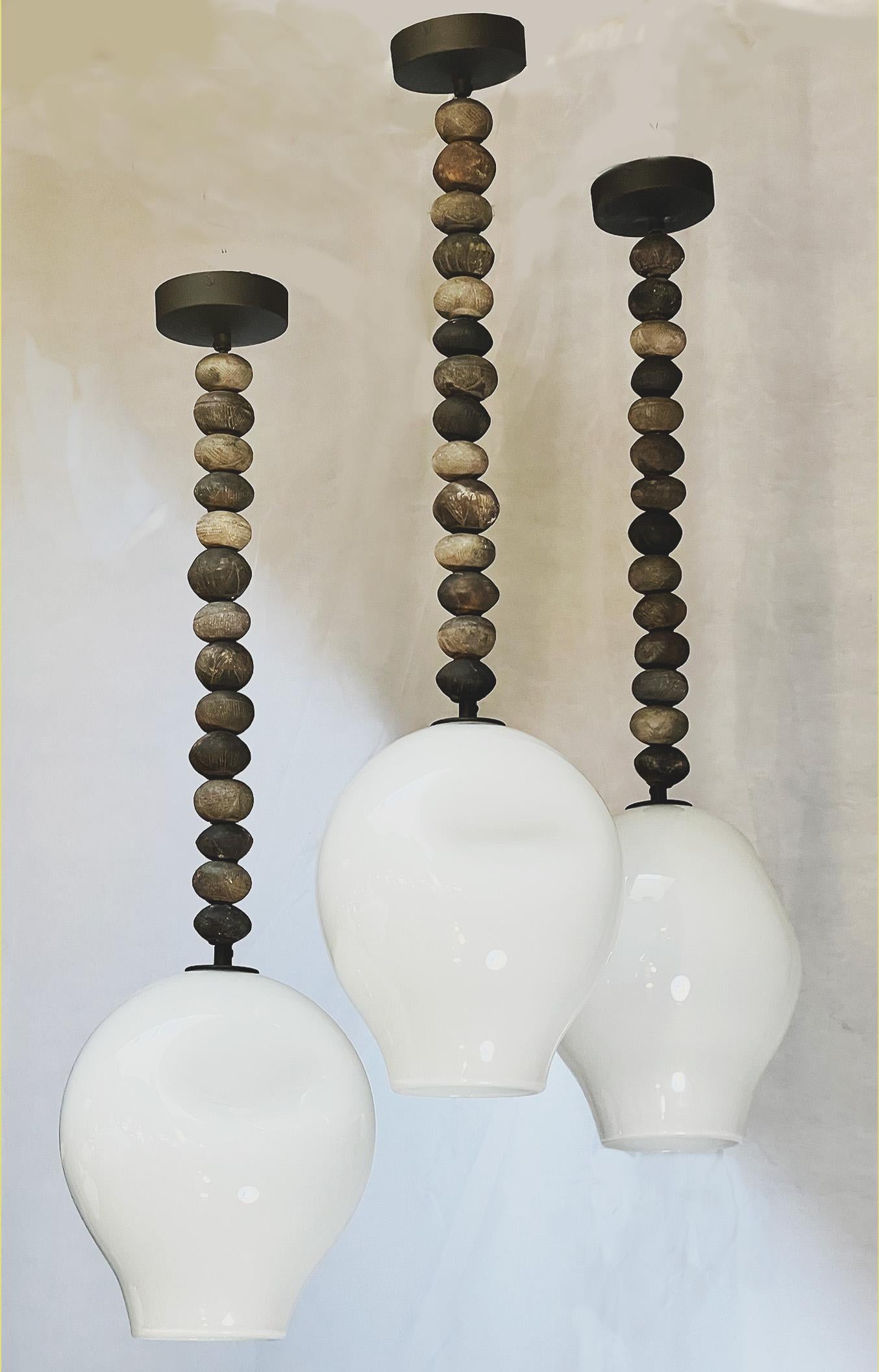 Botswanan African bead pendants with mouth blown milk glass shades For Sale