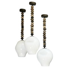 African bead pendants with mouth blown milk glass shades