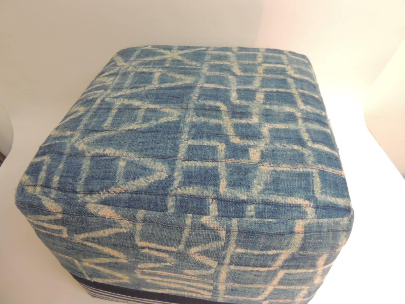 African blue and natural vintage textile re-upholstered square ottoman custom. Stripes of the African strip woven cotton were hand-sewn together in order to create this unique tribal pattern. The top and side panels are padded to give this piece a