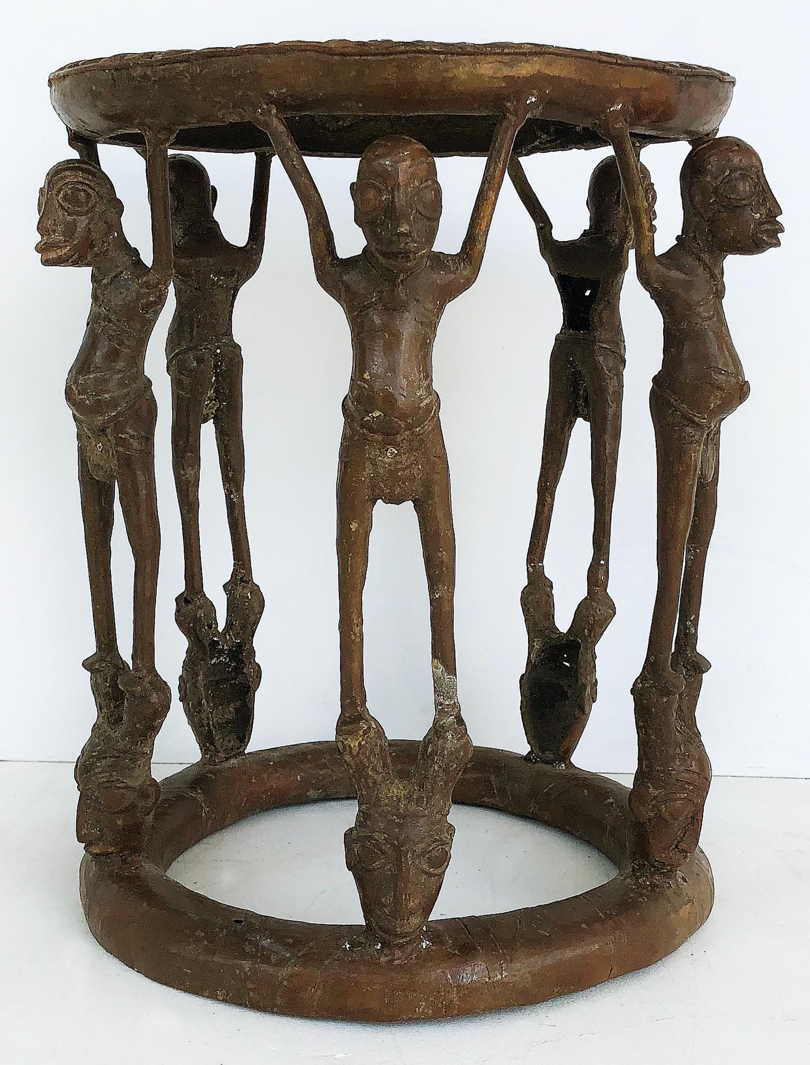 African (Cameroon) bronze figural occasional/side table, mid-late 20th century

Offered is an African bronze figural occasional/side table from Cameroon dating to the mid-late 20th century. This two-tiered table has bronze figures resting above