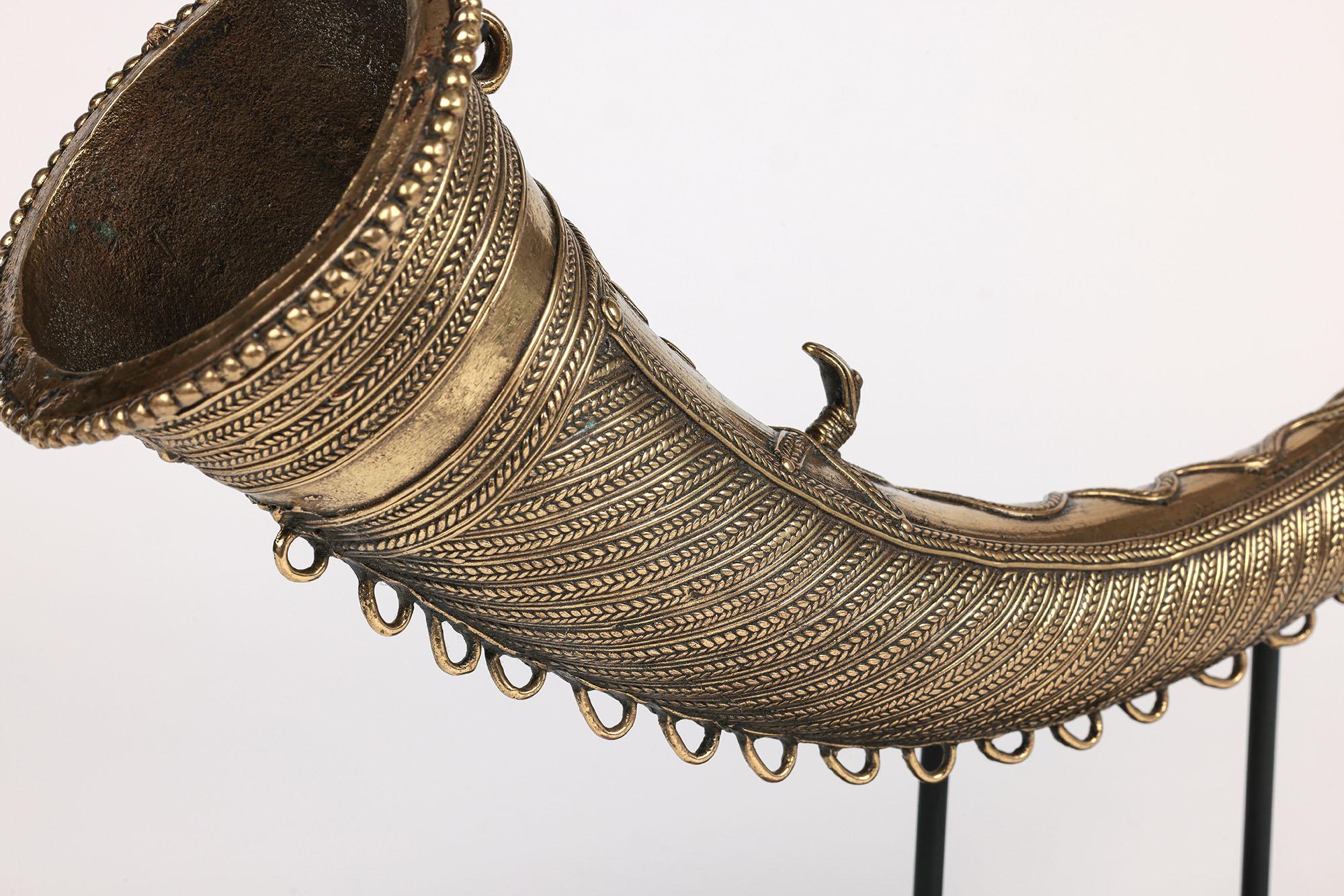 A stunning African lost wax brass hunting horn attributed to originate from the Cameroon and dating to the latter 19th or early 20th century. The horn, originating from a private UK collection, is made in heavy cast brass with leaf banding applied