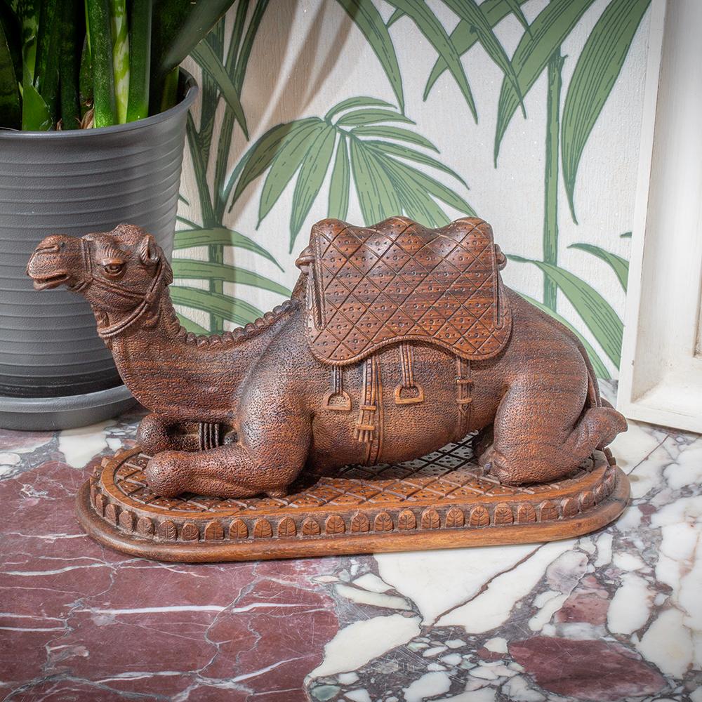 From our Decorative collection, we are pleased to offer this finely carved African Camel Sculpture.

The camel is carved from dense camel thorn wood, a material valued for its durability and deep tone. Shown in a recumbent pose, the camel rests upon