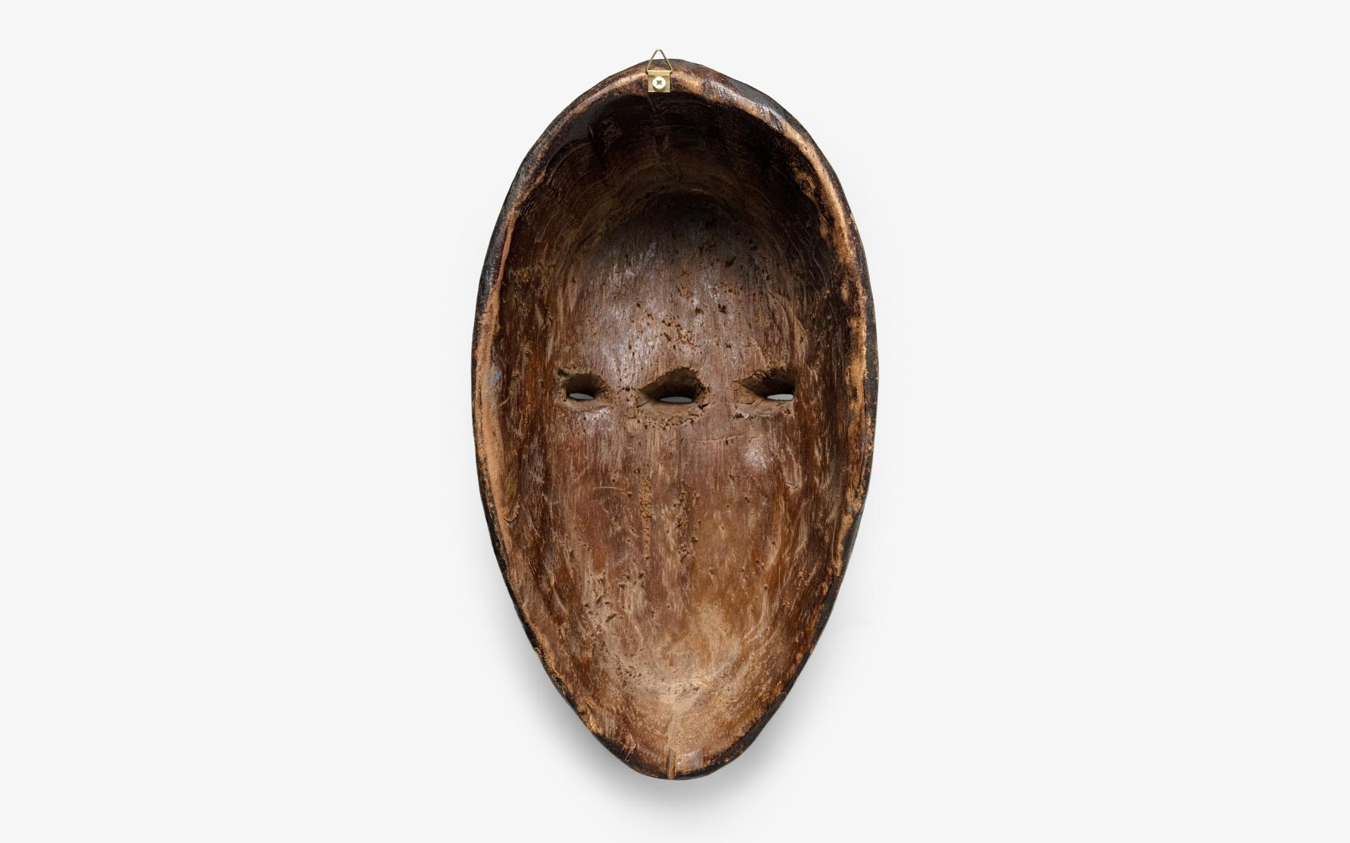  A unique mask, handmade by artisans in the Punu region of Gabon. This mask has been crafted using wood carving techniques and adorned with polychrome tempera paint, giving it a distinct and one-of-a-kind appearance. It stands as a collector's