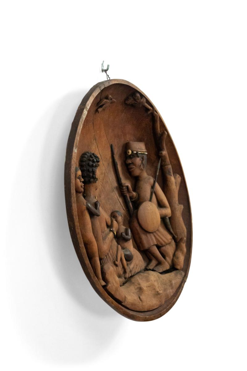African (19/20th Century) concave bowl shaped wall plaque with family figures.