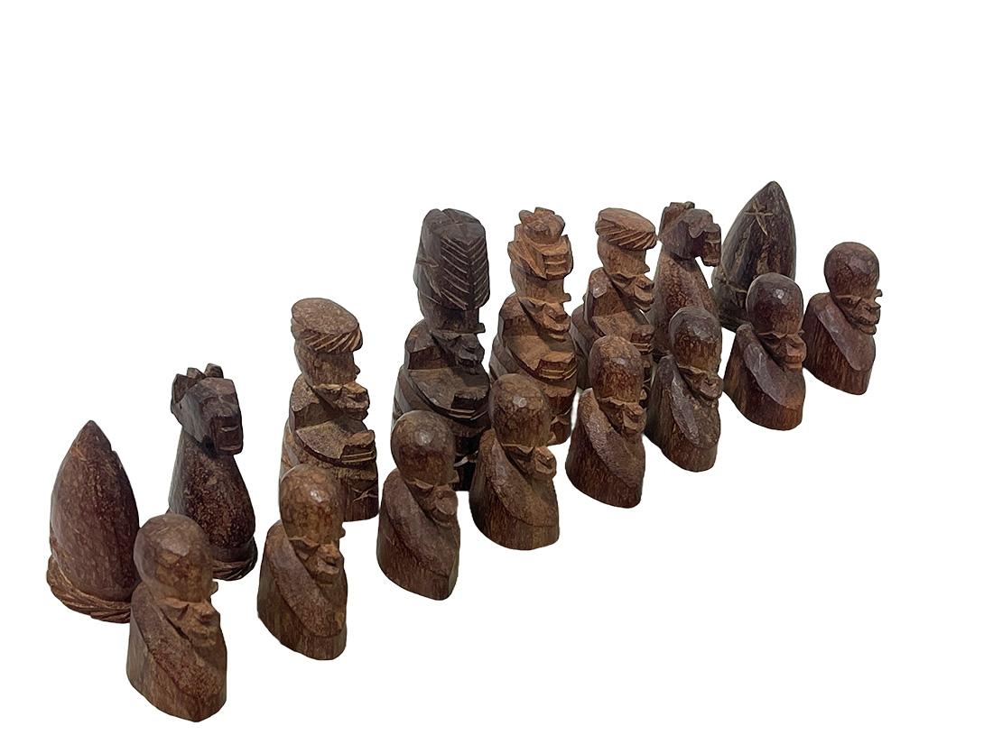 African chess set of Namibia

An African chess set with figures of Namibia, made by hand of walnut wood in natural dark and light brown color on a marble look style lidded chess board box, made of plastic
Each set per playing person exists of a King