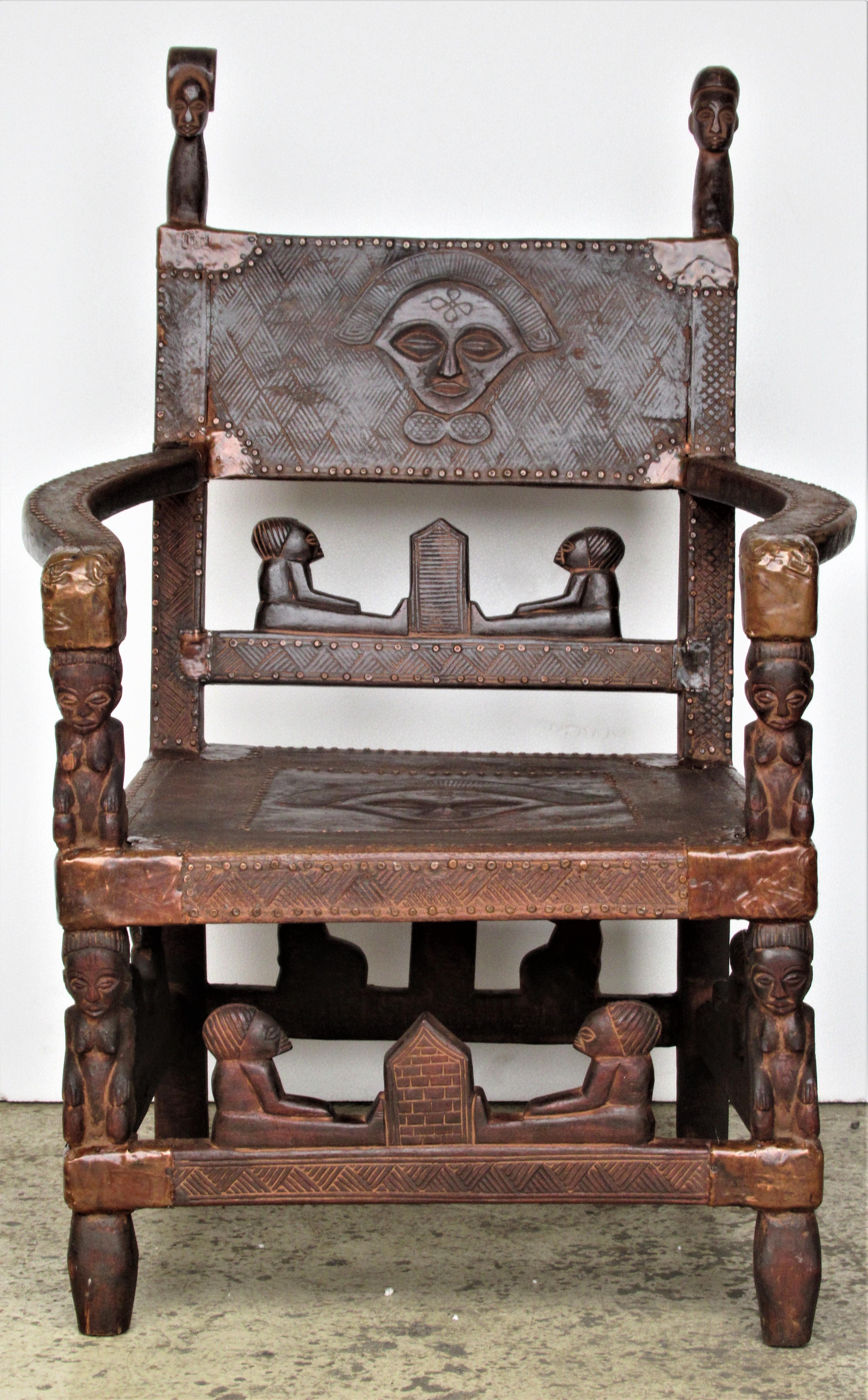 African chief throne chair from the Chokwe tribe of Angola or the south western part of the Peoples Republic of the Congo ( formerly Zaire ) hand-carved wood with copper brass metal fittings and rivets. This chair was a deaccession from a private