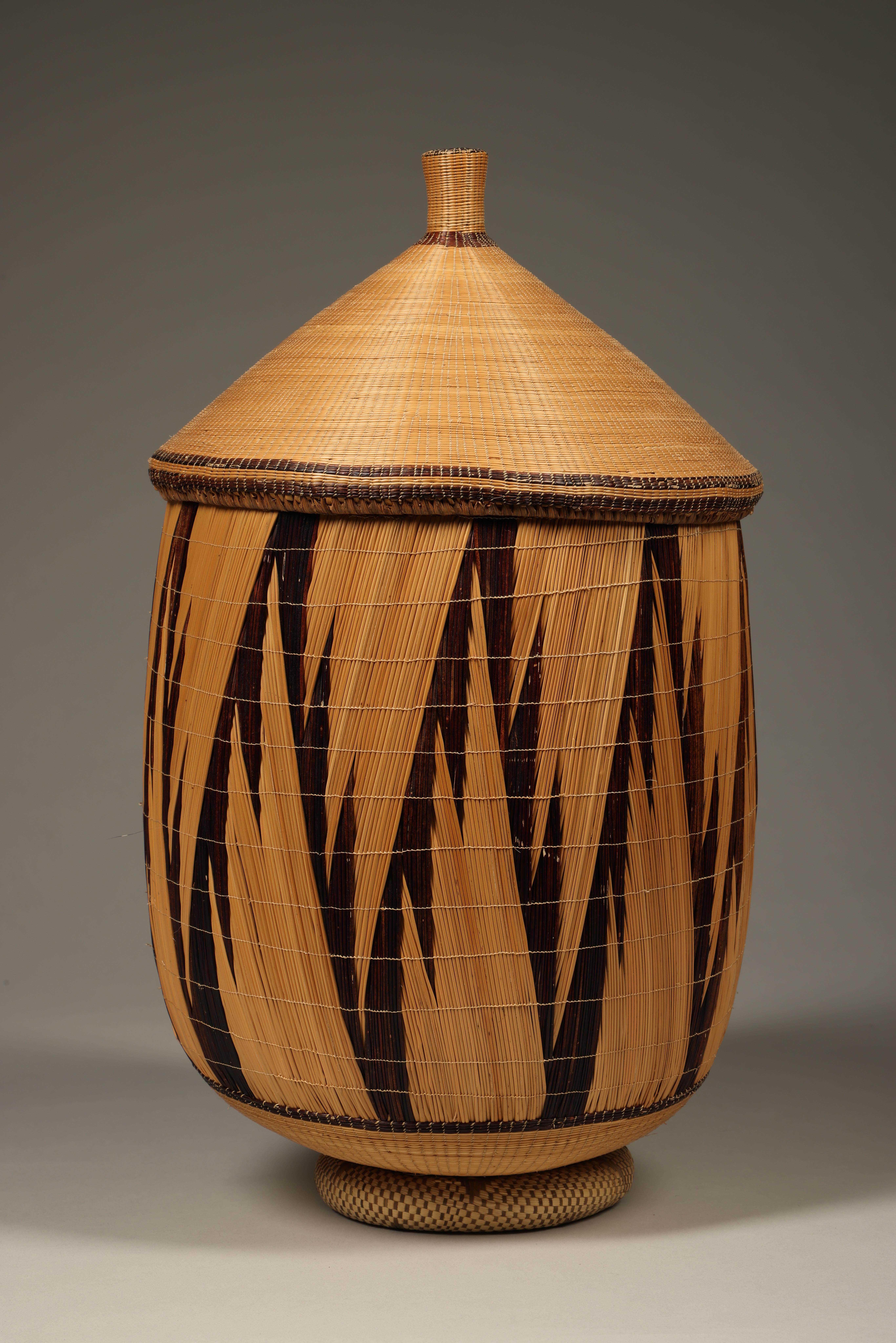 Tutsi hand woven basket with fine vertical geometric designs, and lid.  Includes extra woven 