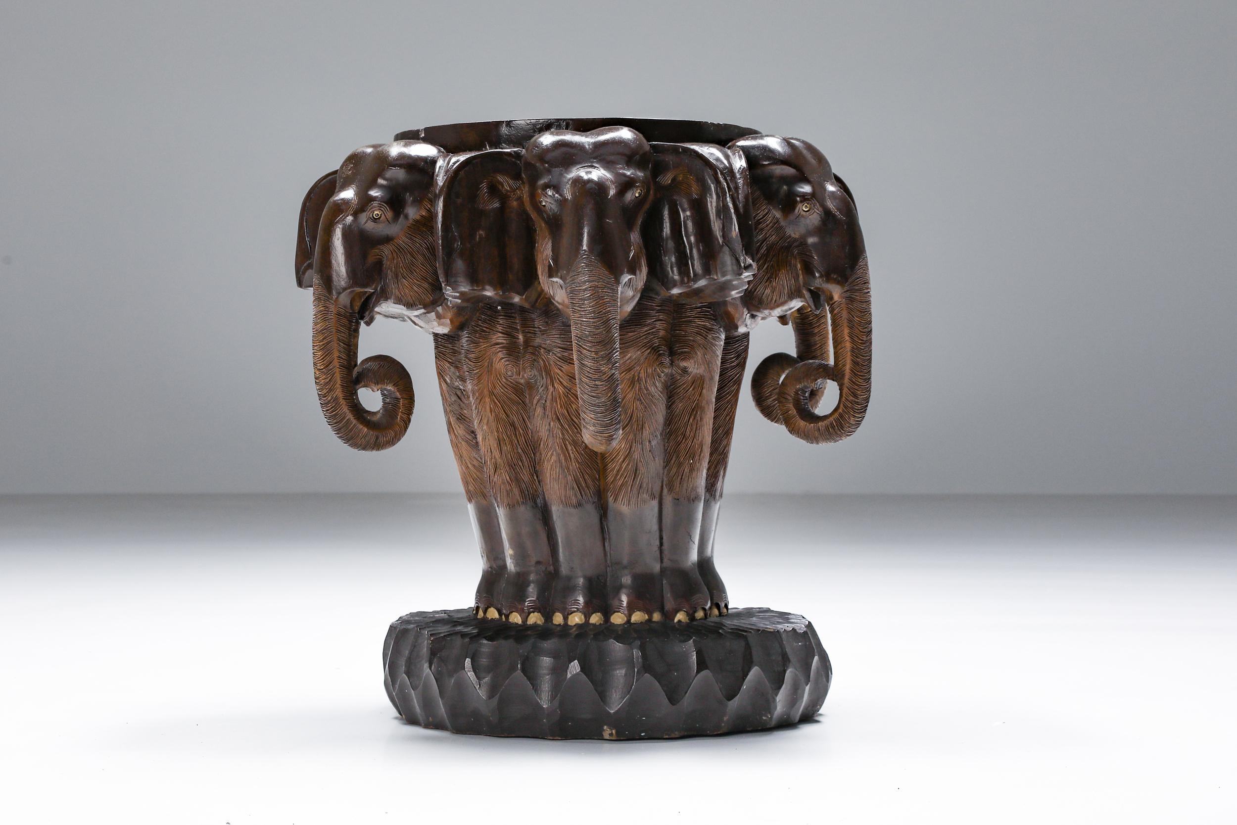 African hand-carved elephant table, a magnificent piece of art that transports you to the heart of the 20th Century. This stunning side table, designed to complement our elephant chair, exudes a tactile sense of texture, a testament to the skill of