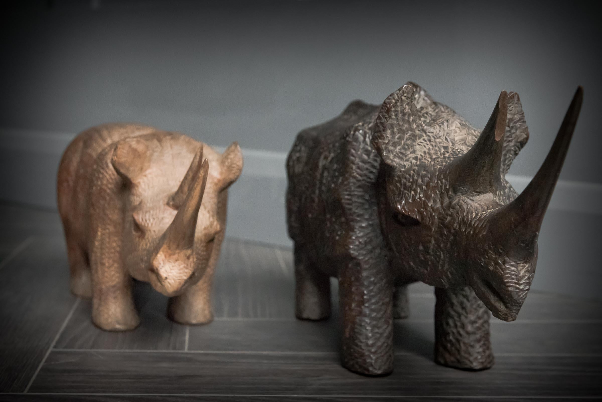 Hand-Carved African Hand Carved Pair of Black and White Rhinos For Sale