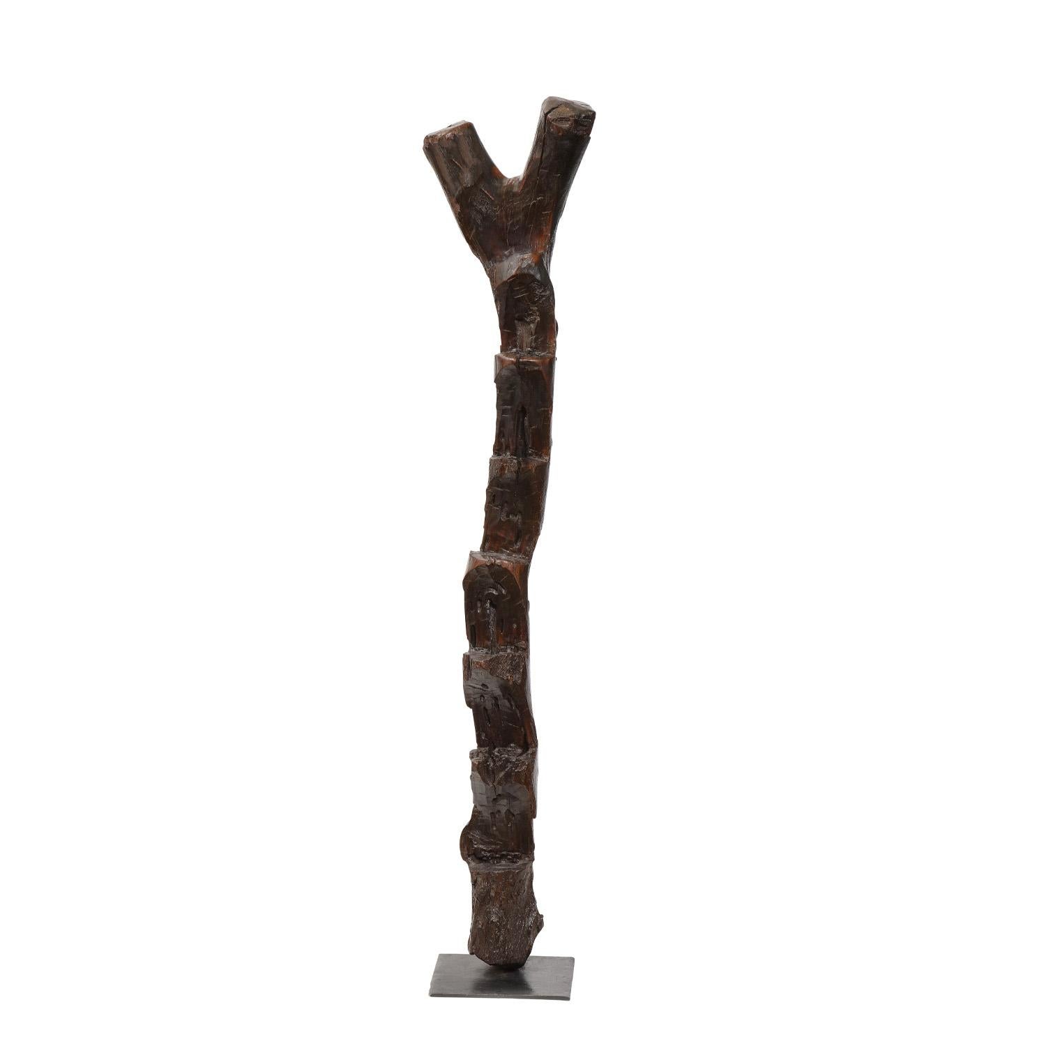 Hand-carved wooden ladder on a black square base originally used to to access multi story residences built in cliffs by the Dogon Tribe, Mali 20th century. This is a stunning accent for any room.