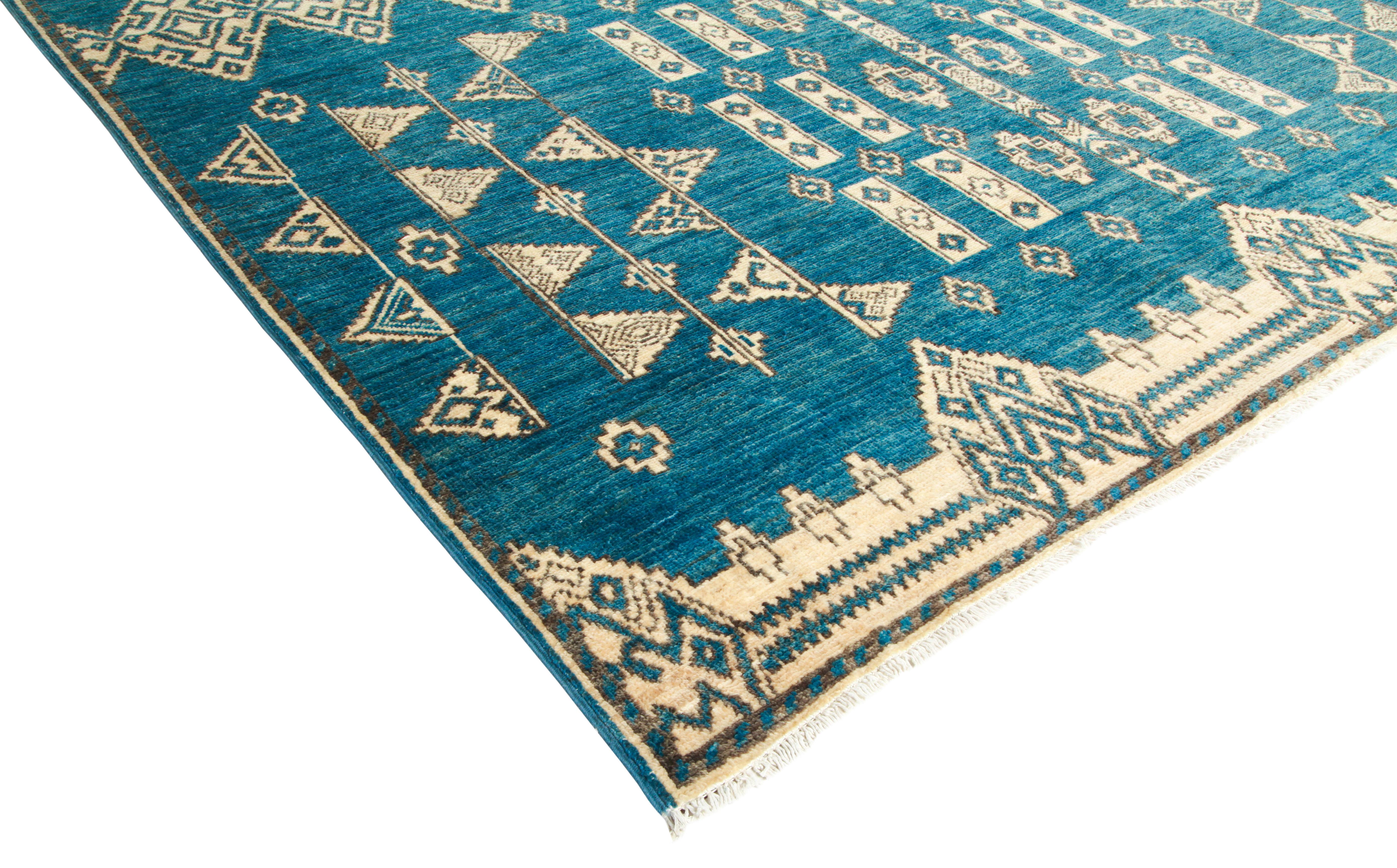 Color: Blue - Made In: Pakistan. 100% Wool. The rich textile tradition of western Africa inspired the Tribal collection of hand-knotted rugs. Incorporating a medley of geometric motifs, in palettes ranging from earthy to vivacious, these rugs bring