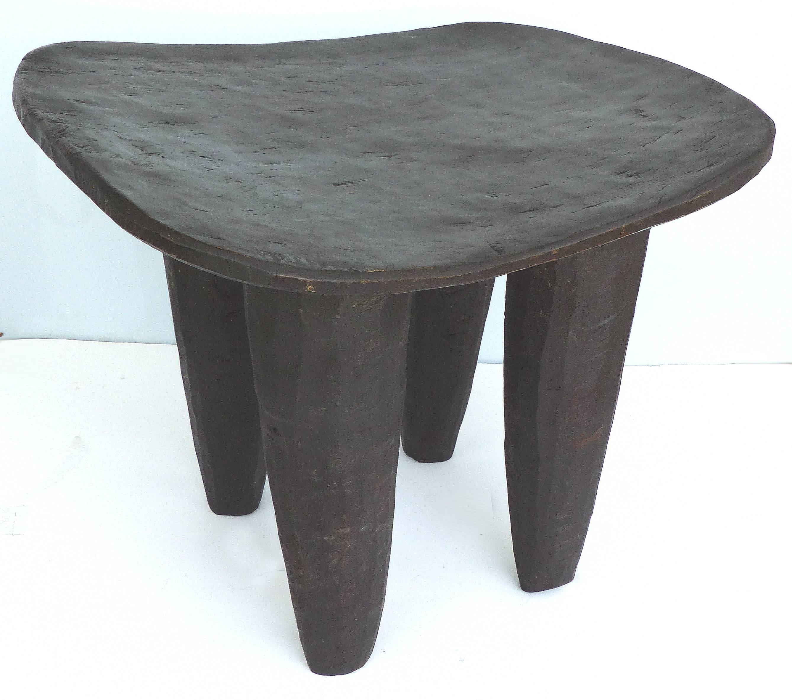 Offered for sale is a 20th century hand-carved Senufo stool from the Cote d'Ivoire. The chair is very stable and quite sensual. The wood shows lovely rustic textures of the hand carving. It makes a wonderful side table or stool. Height is measured