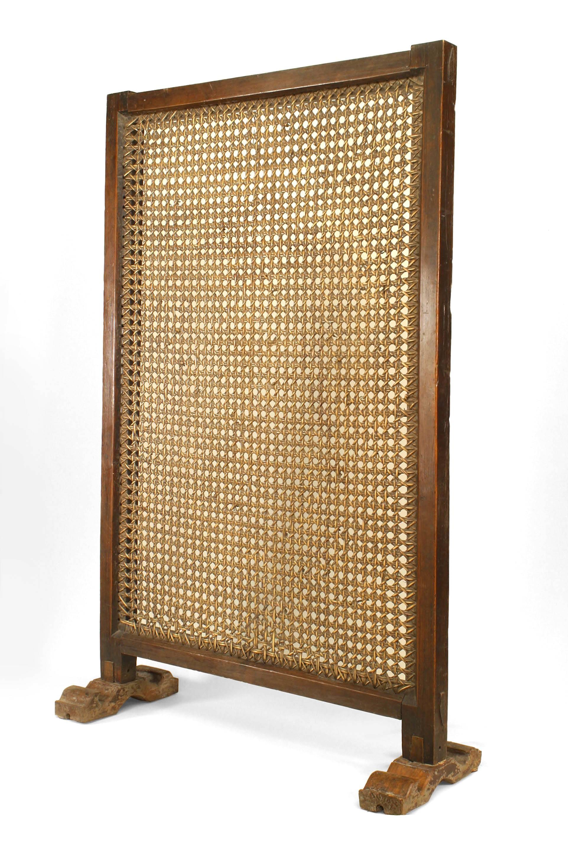 African hardwood framed large single panel screen on a stand with a heavily wicker woven design.
