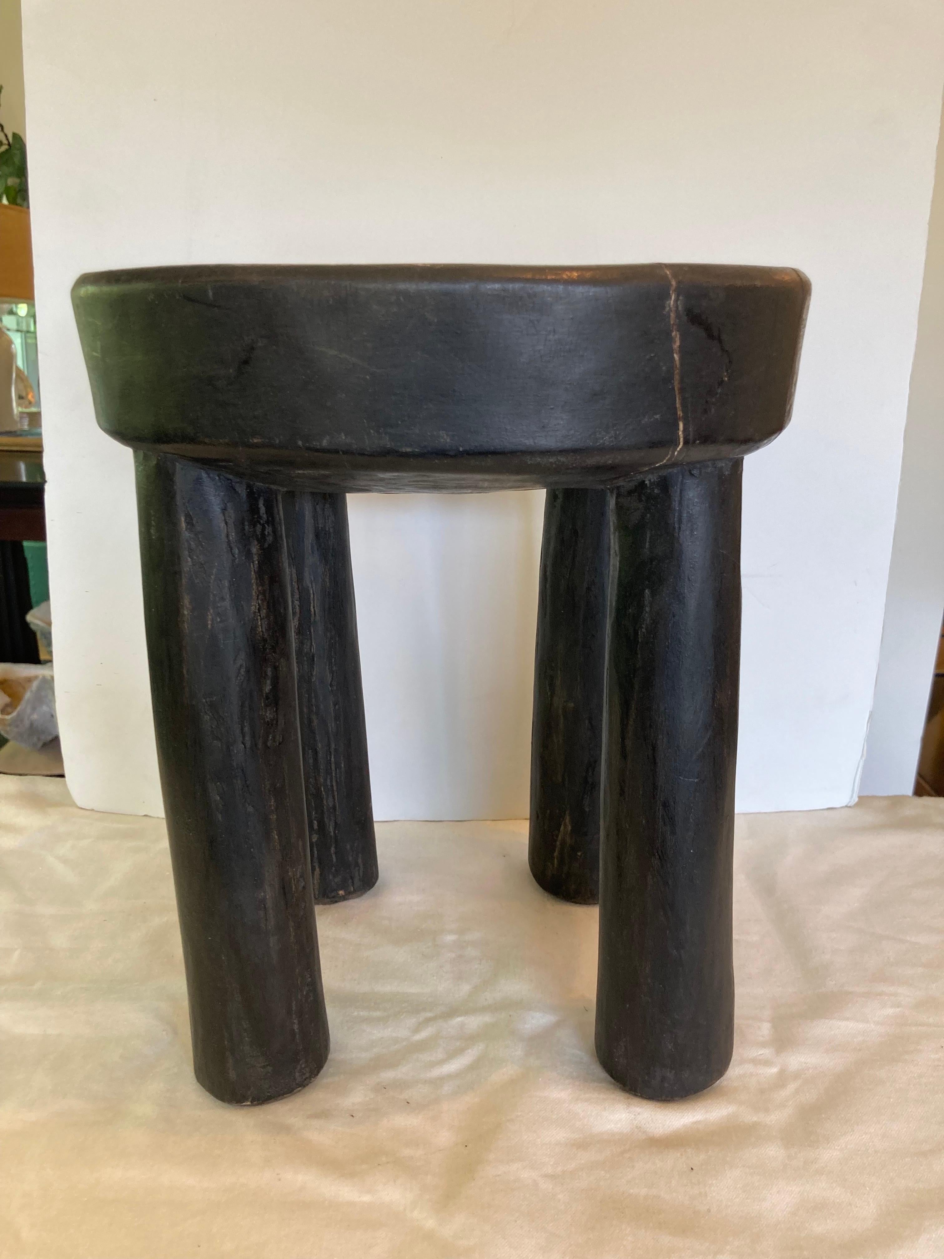 Western African hardwood stool carved from a single piece of wood.... makes a great side table as well ..... flat top.