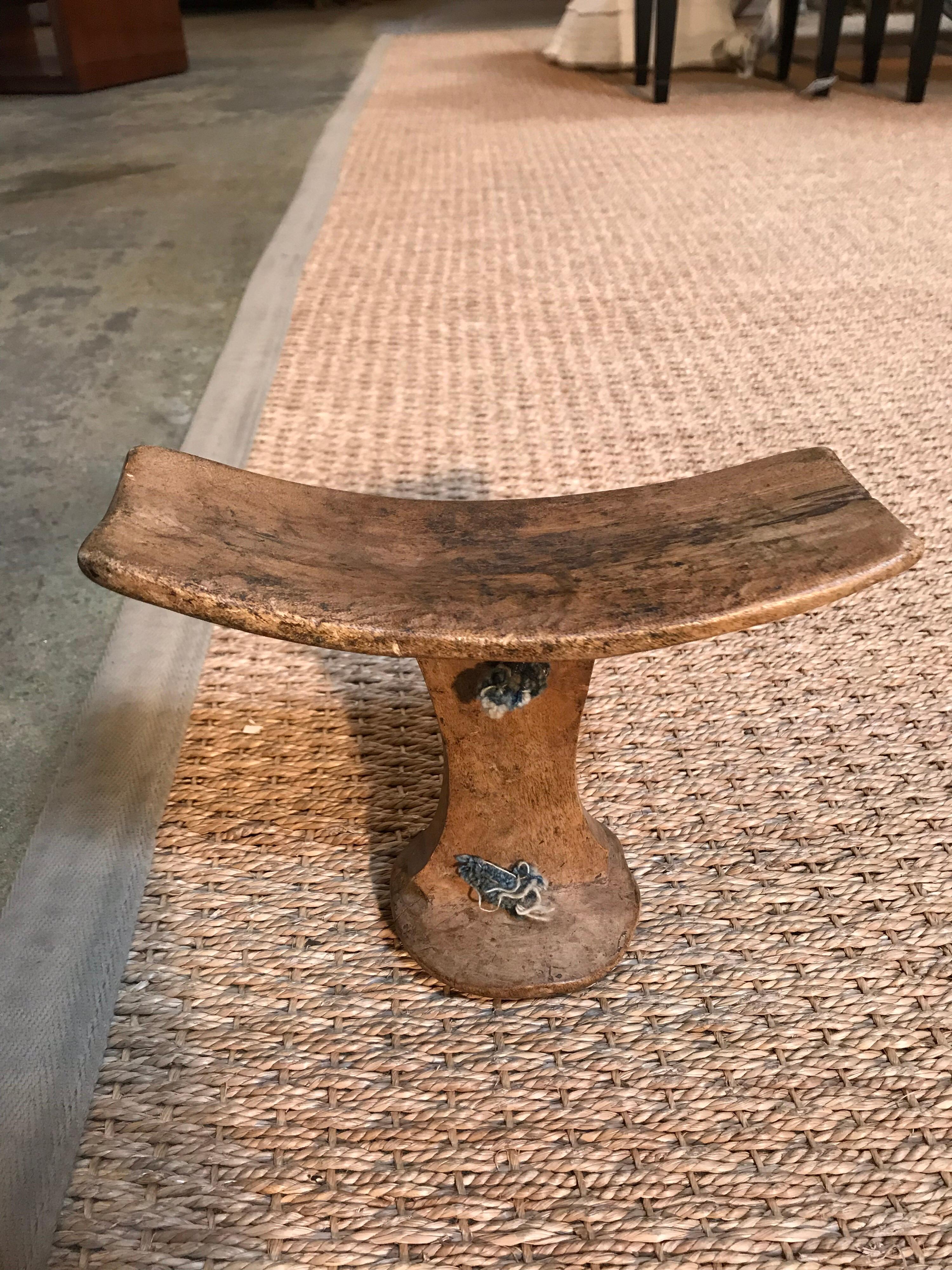 This 19th century African head rest is hand carved with rope handles.