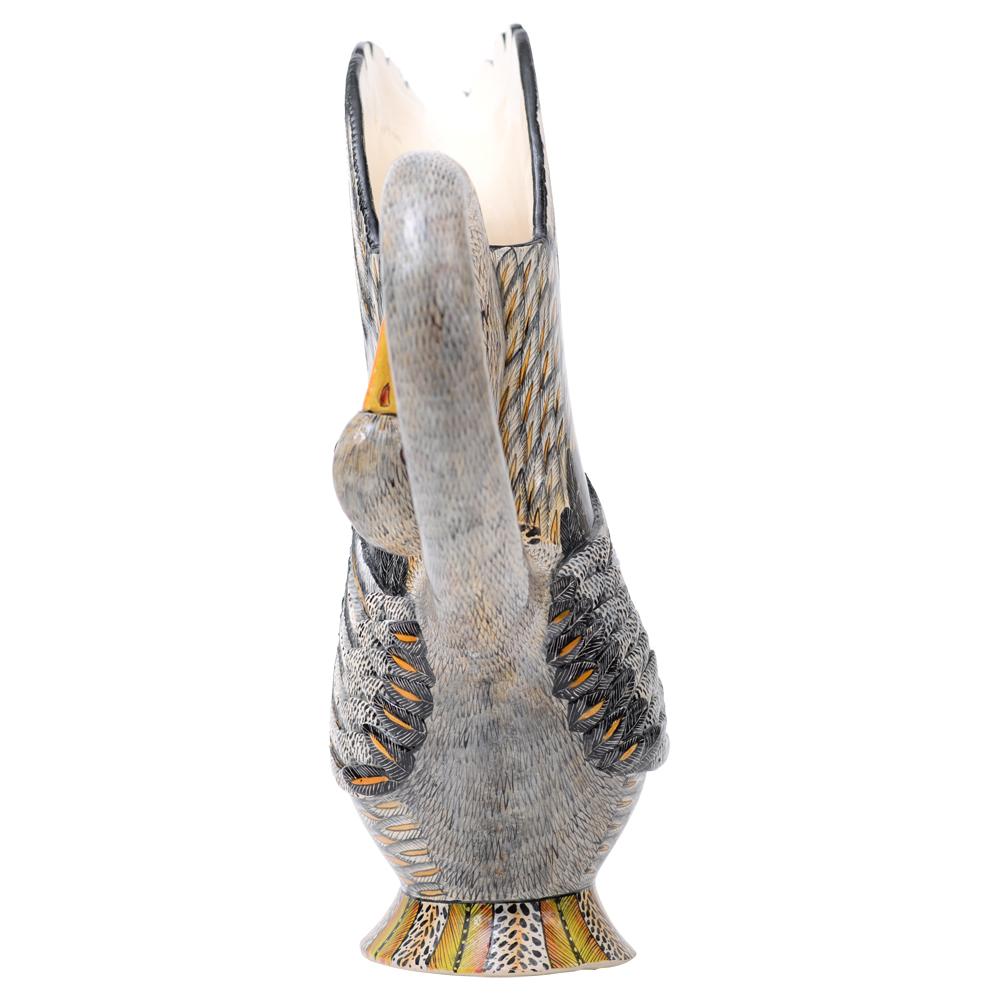 Crafted by Love Art Ceramics, the African Heron Bird Jug pays homage to Southern Africa's legacy of conservation and symbiosis with its diverse ecosystem. Sculpted by Sbu Ndaba and painted by Zinhle Nene, this 13-inch marvel embodies the essence of