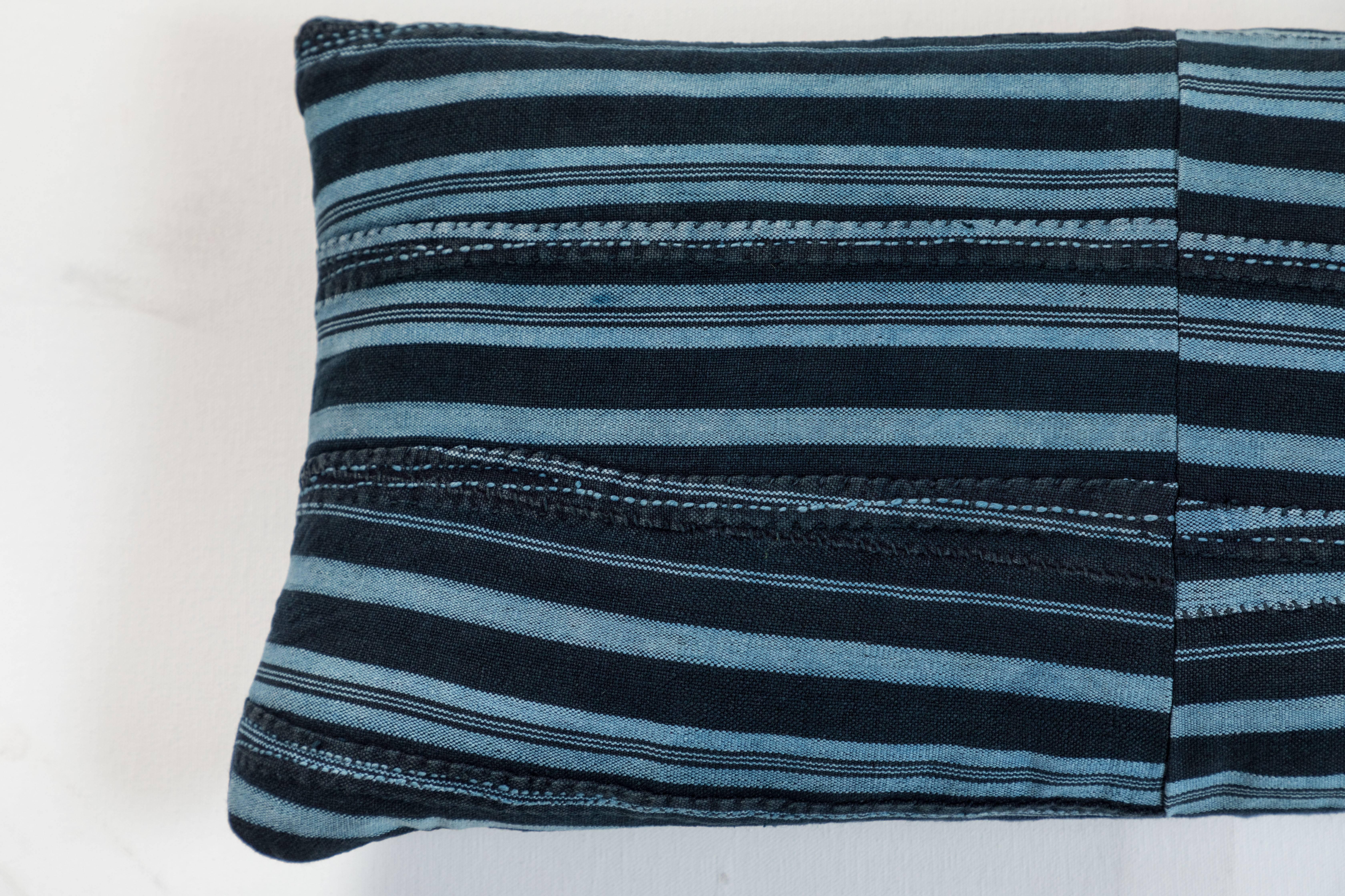 Pillow made using vintage Ashante textile. Handwoven in Nigeria by the Yoruba Tribe. Long strips of cotton hand woven on narrow backstrap looms.  Blue linen back, invisible zipper closure and feather and down fill. 


