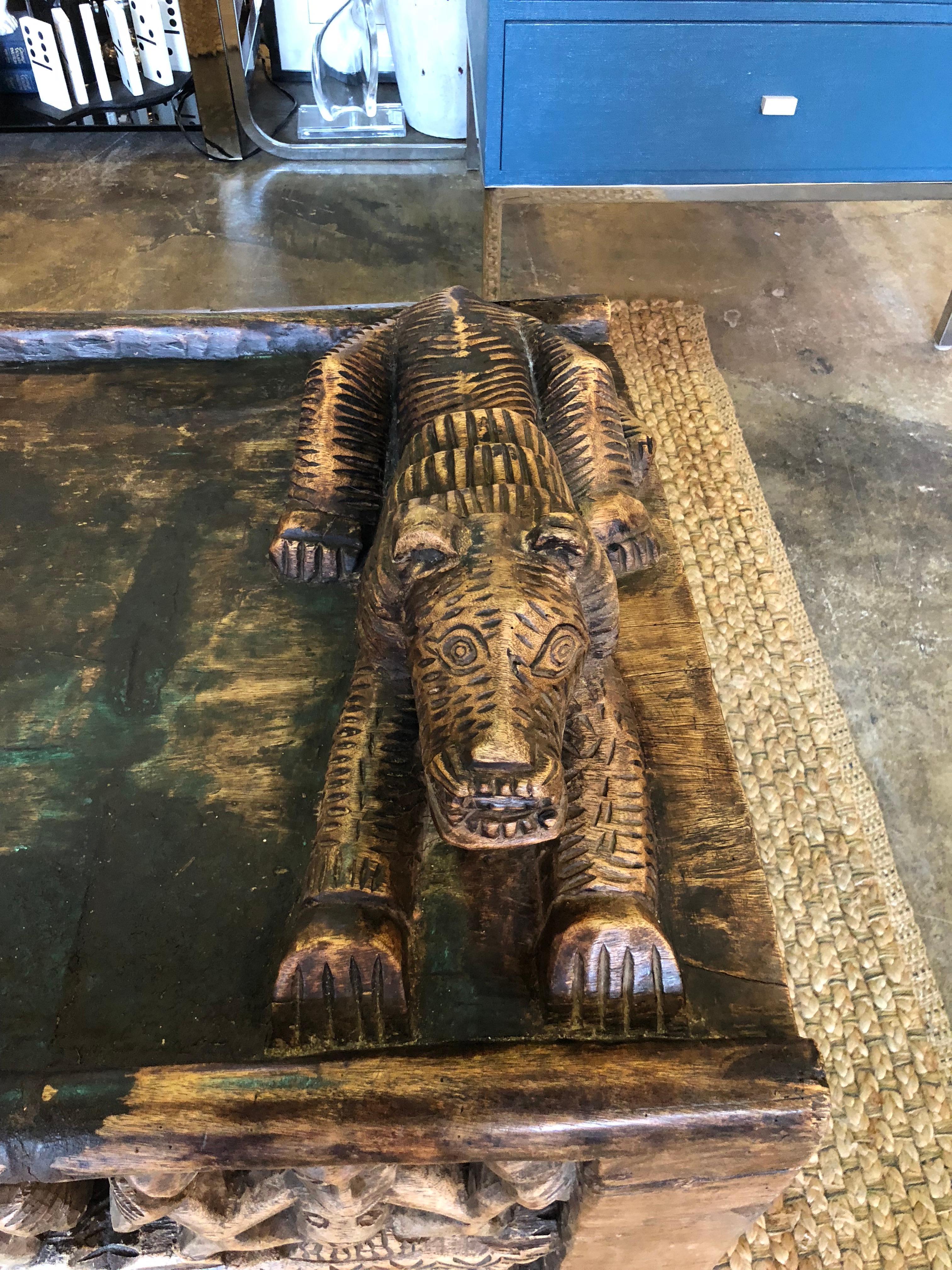 A hand-carved African King's bed carved from one piece of wood comprising of a carved leopard pillow and carved figural people on both sides. One of the best examples we have ever seen.