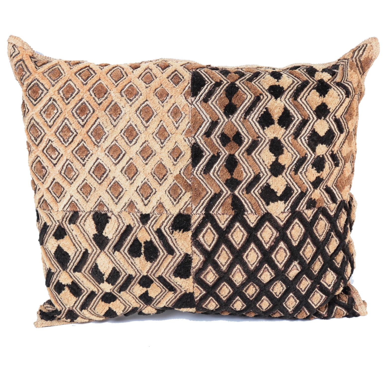 Kuba Shoowa pillow, crafted from a raffia pile cut cloth from the Kuba people. Traditionally this type of cloth was valued in the community and would serve as a type of currency. The patterns are unique to each creation such as this one, divided