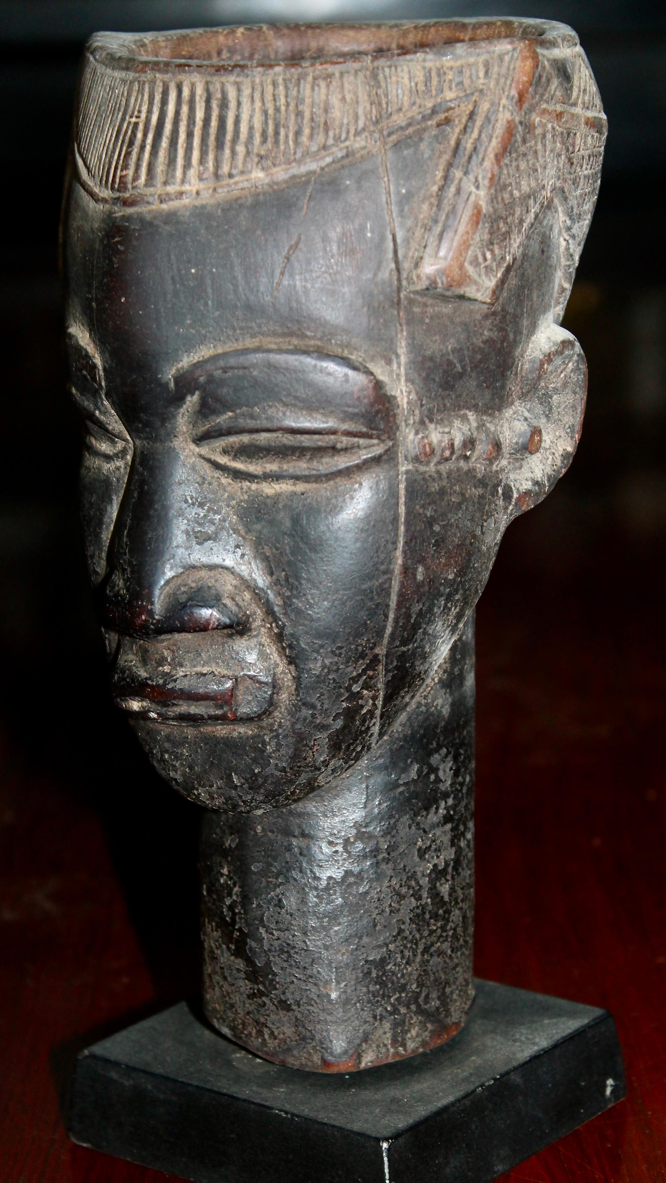 A Kuba Head as a cup. Rich dark patina. Mount included. From The Late Bryce Holcombe Collection. Bryce was the founding director of Pace Primitive, and a personal friend.
