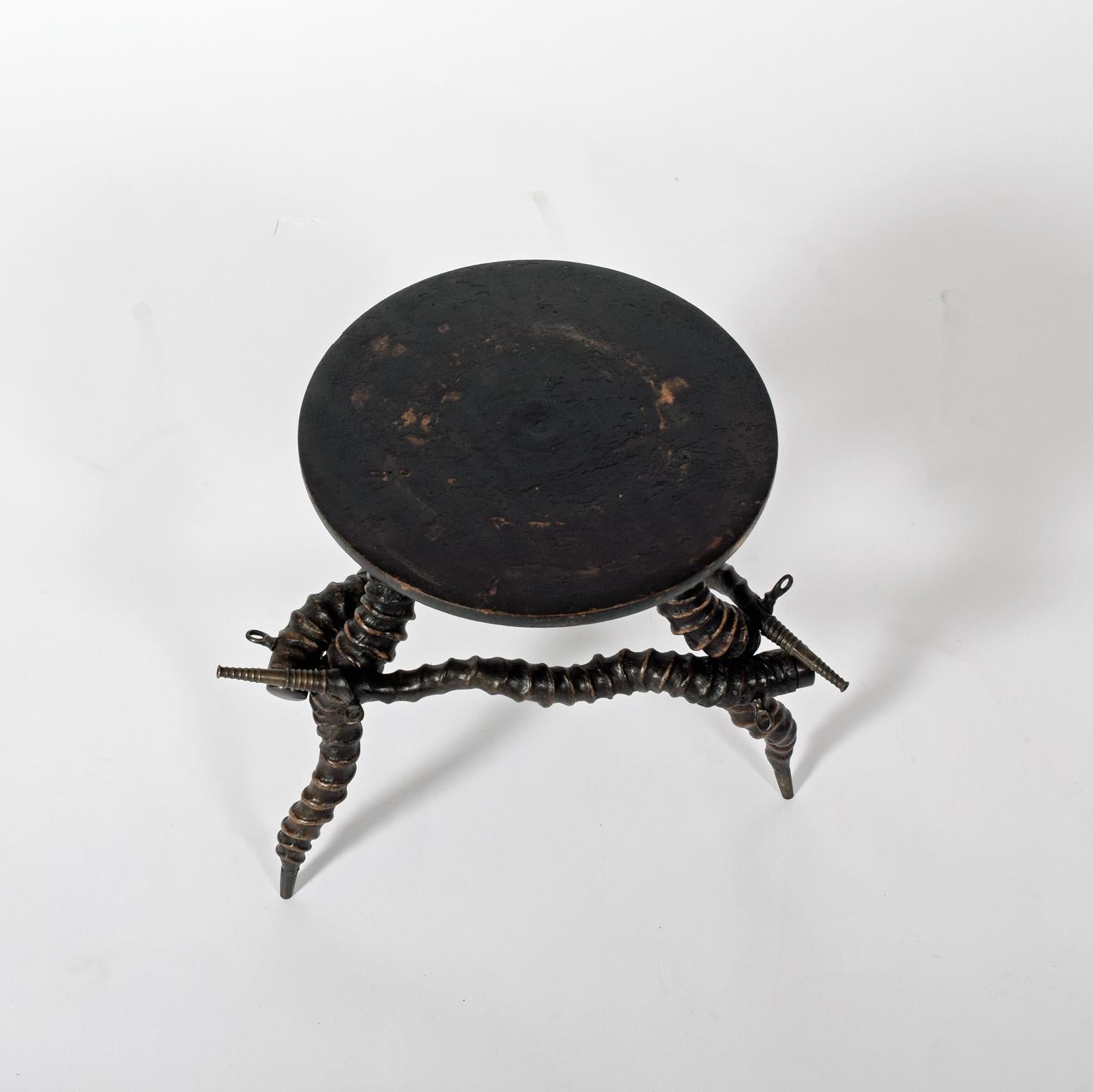African Kudu horn side table six horns connected with brass fittings and feet, ornaments, round wood top probably made in the 1930s.