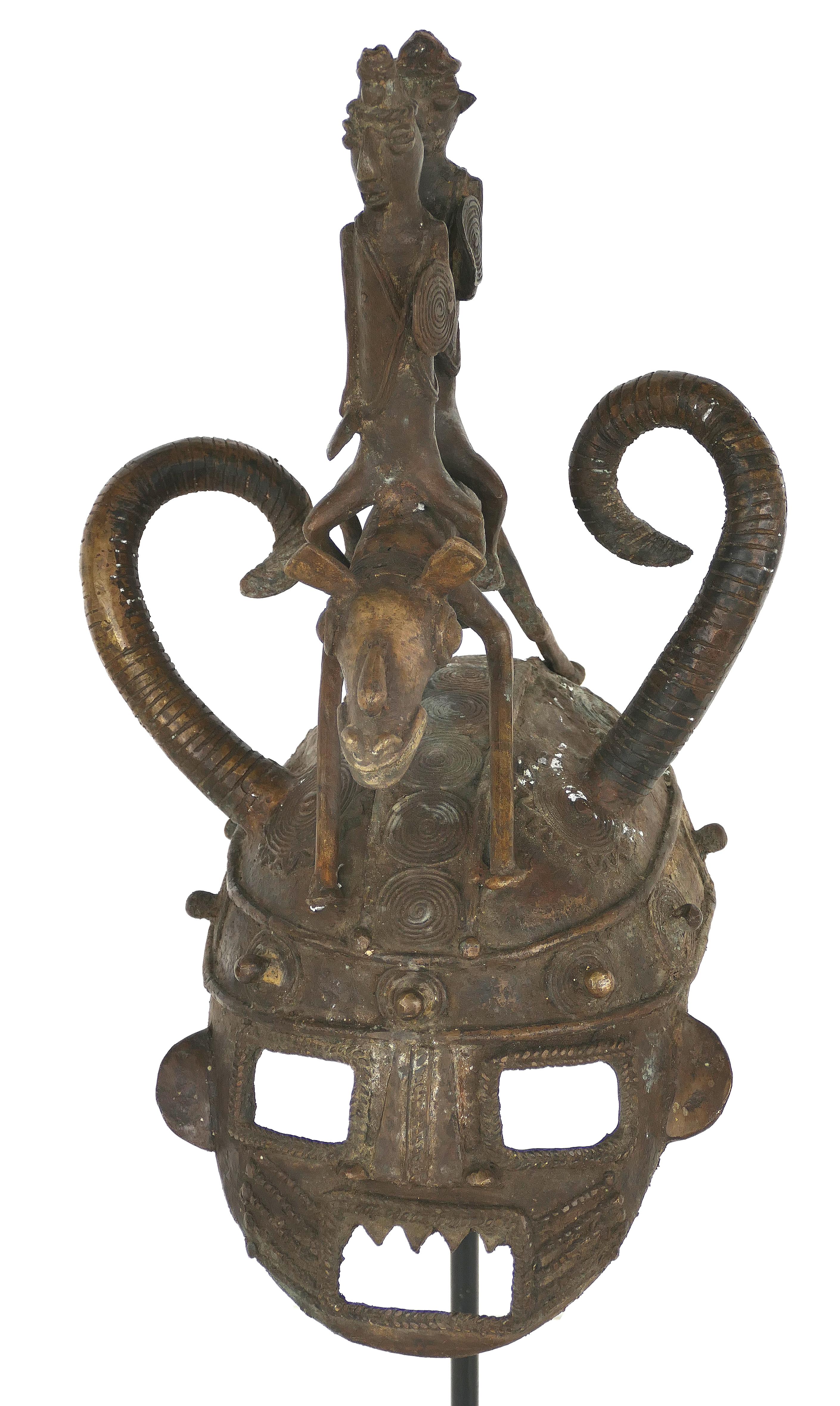 African Mali cast bronze figural helmet on stand, 20th century

Offered for sale is a mid-20th century African lost wax cast bronze figural helmet on a stand from Mali. Mali, officially the Republic of Mali is a landlocked country in West Africa.