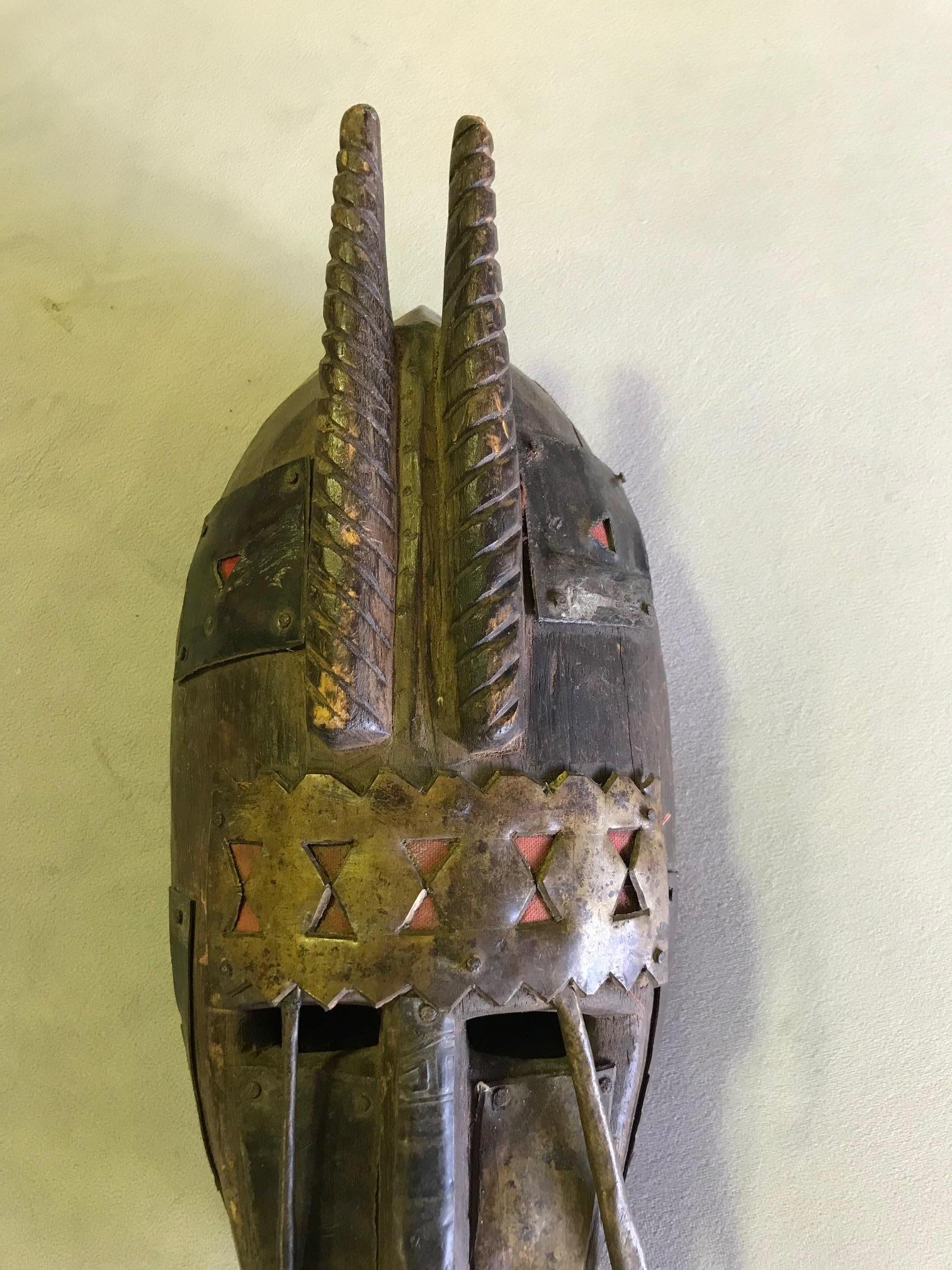 A fantastic mask. Warka masks are usually made of elongated carved wood and covered with copper. They are primarily used by the people of Mali in dances related to numerous societies. 

This mask has a beautiful patina acquired with some age and