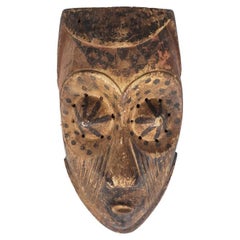 Vintage African mask “Kuba Babuka” in wood and pigments. 20th century.