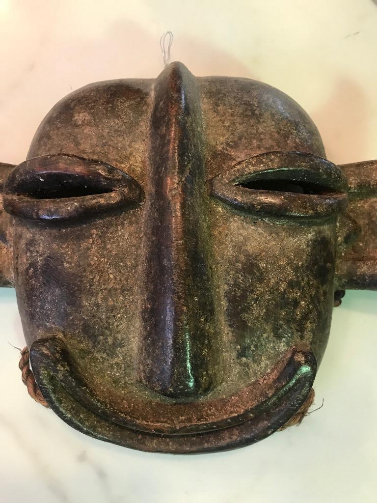 Fantastic piece. Beautiful patina. Likely Hemba tribe of South West Africa who were known for the monkey masks. This particular mask with its happy disposition was made to evoke a beneficiary spirit. 

From a collector of African artifacts.