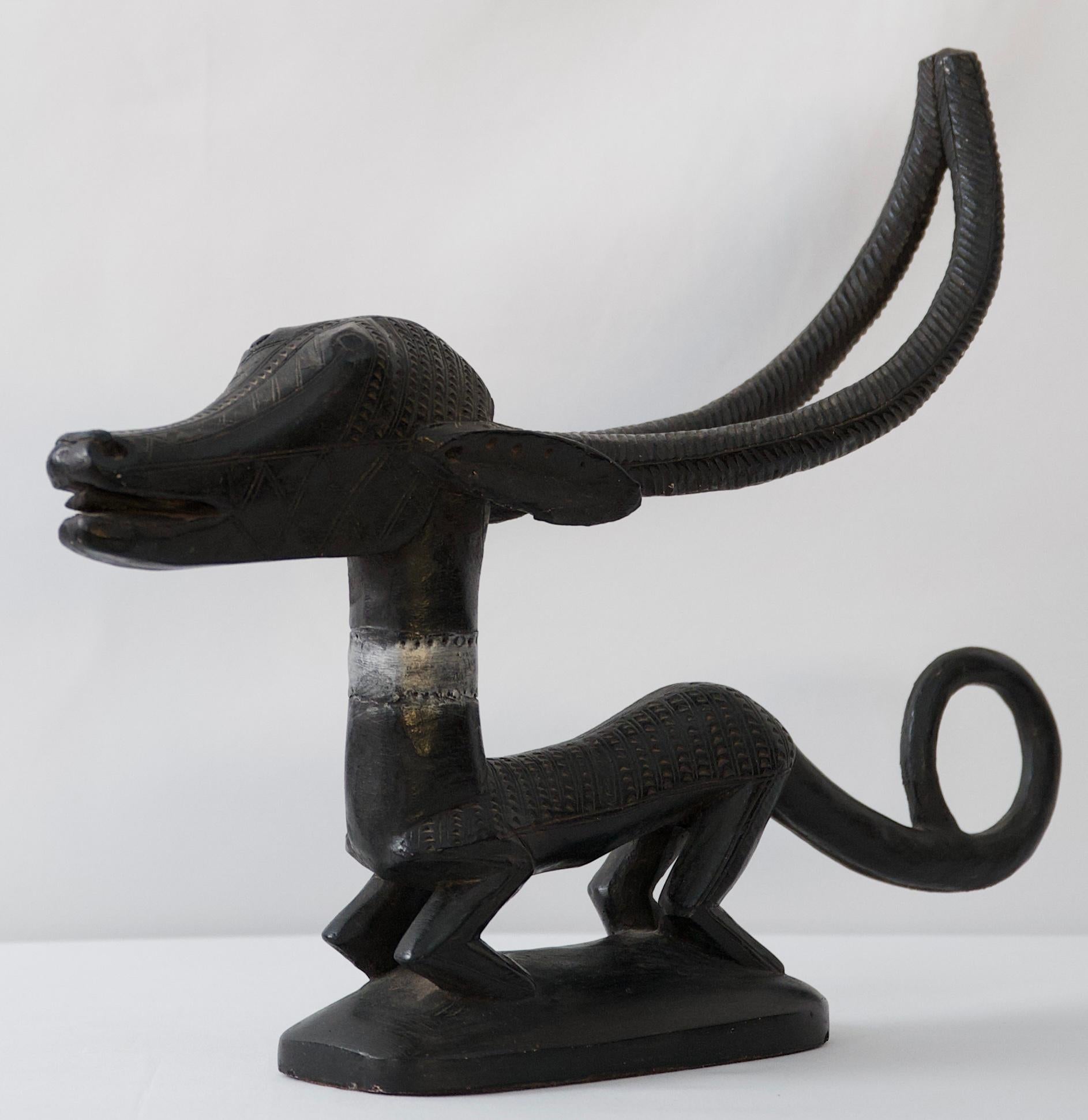 A whimsical depiction of an African mythical dog sculpted by and artist for Austin Productions. 

This eye-catching decorative animal sculpture is made of stone and plaster mix. Would enhance any setting. 

Measures: 20 1/2