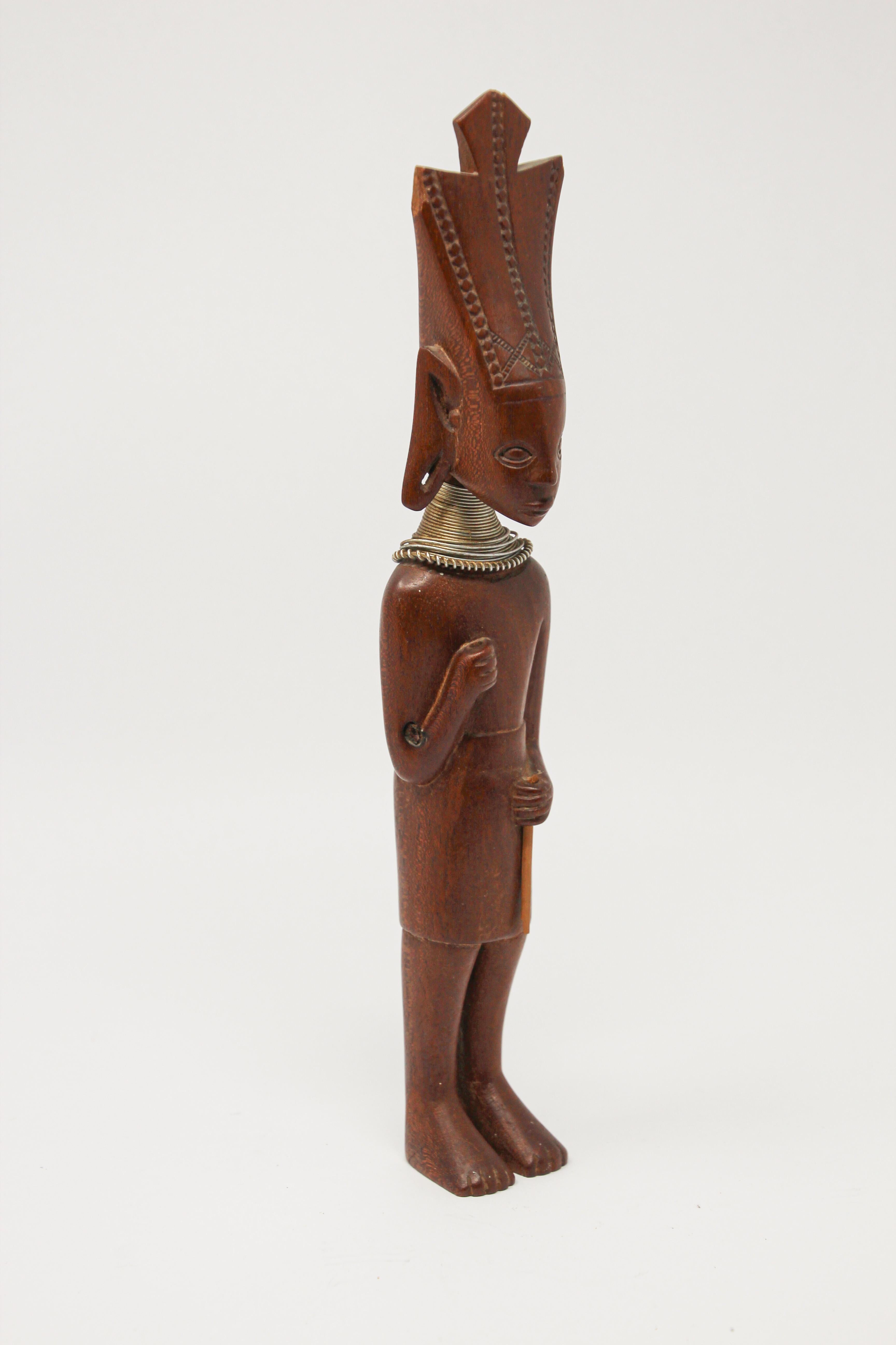 Hand carved West African tribal wood carved sculpture of a standing man, Africa tribal Art Decor.
Ndebele tribal sculpture featuring an elongated standing man with a crown and metal choker.
Very simple modern look carved ethnic